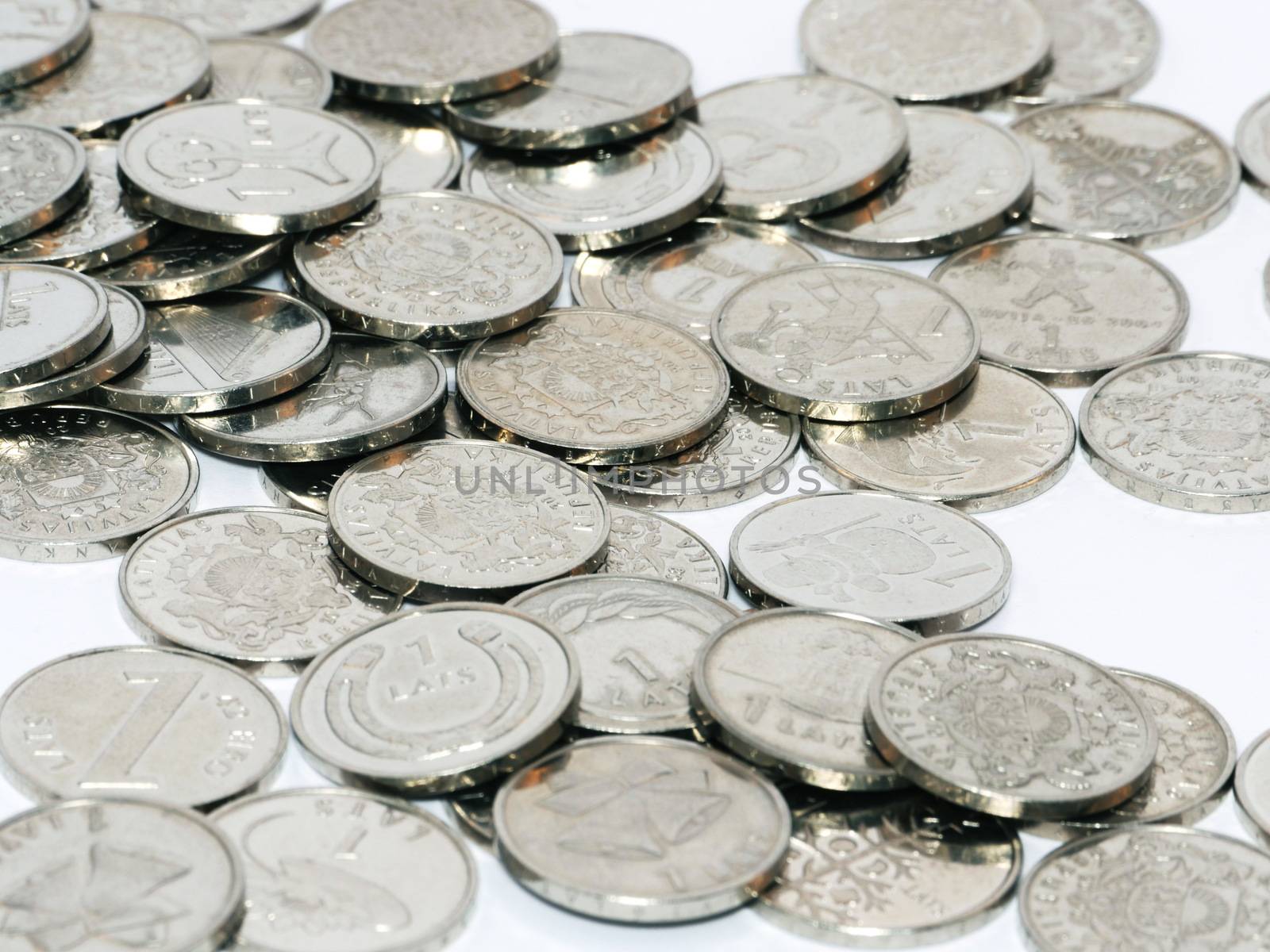 Bunch of Latvian lat coins on white background