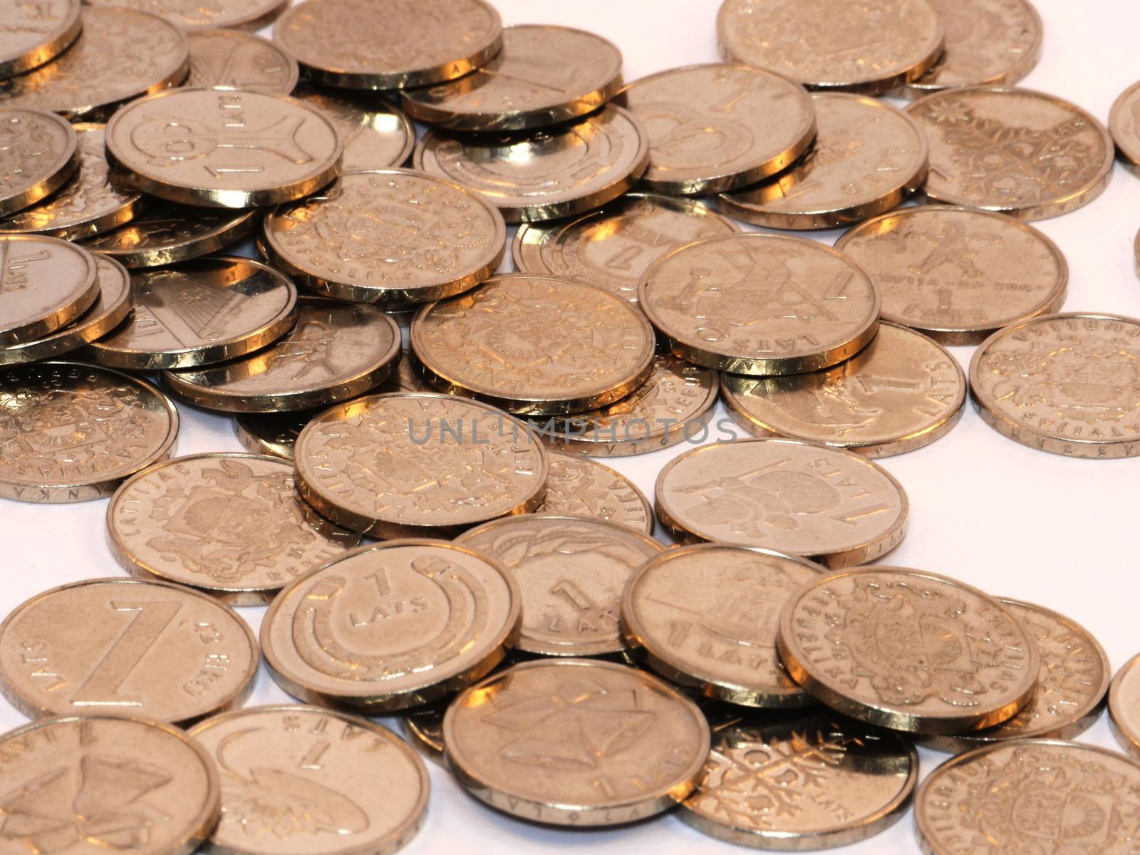 Bunch of Latvian lat coins on white background