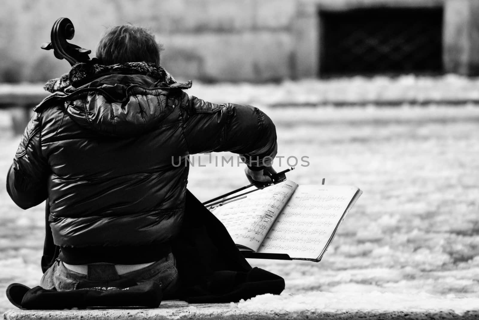 a musician plays his cello after an unusual snowfall in rome