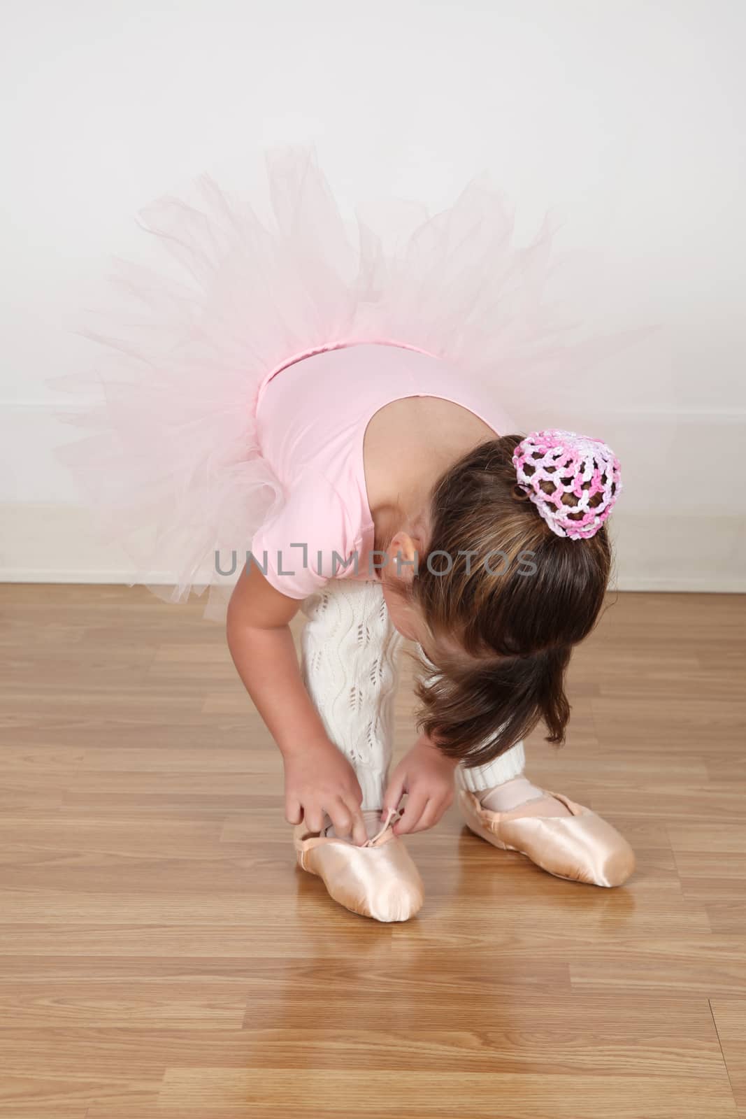 Little Brunette ballerina in the dance studio