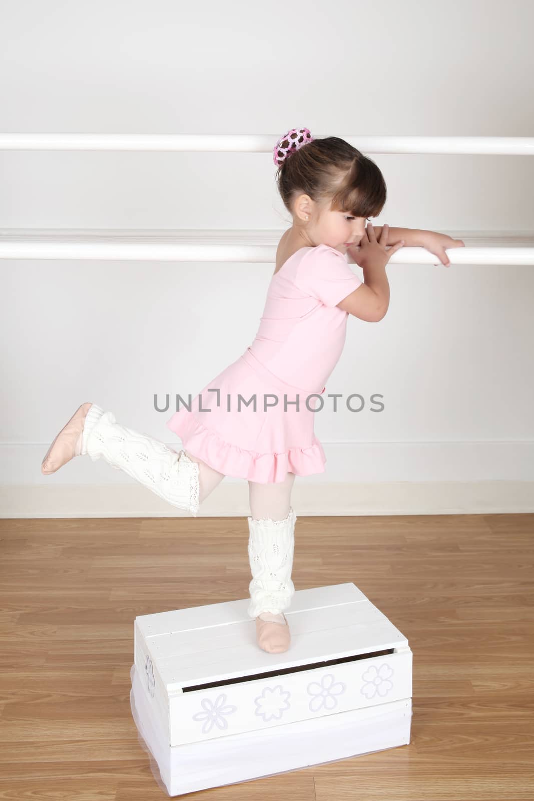 Little Brunette ballerina in the dance studio