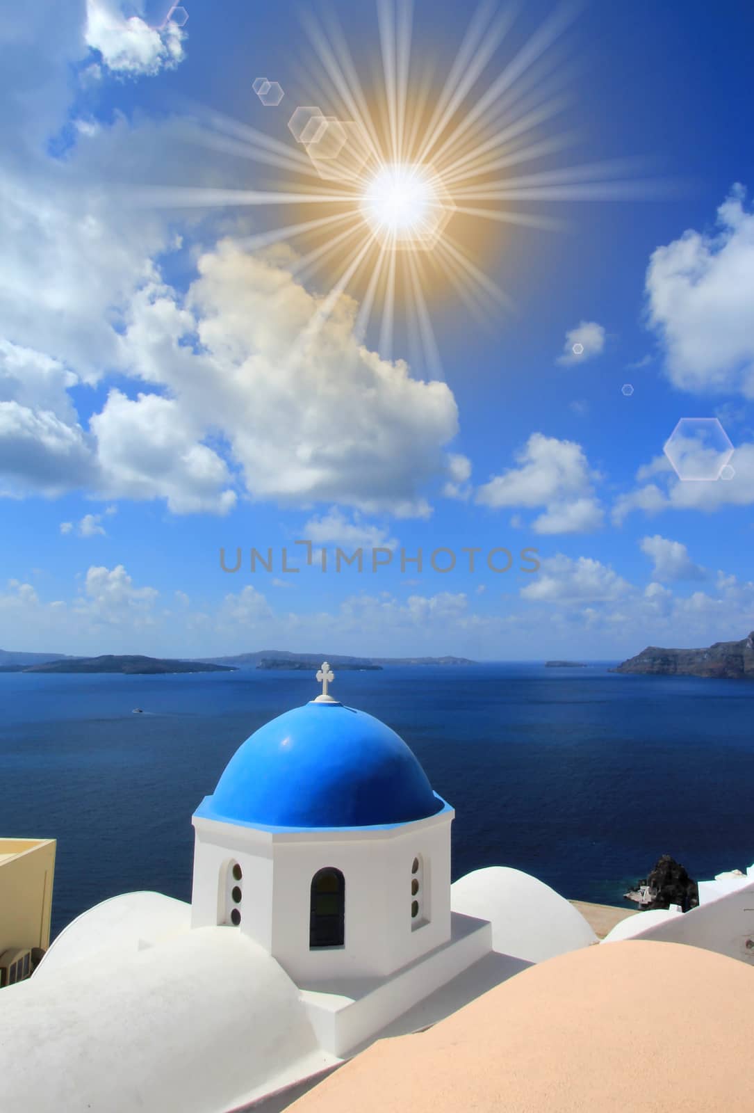 Famous blue dome of orthodox church on the sea background in Oia, Santorini, Greece.