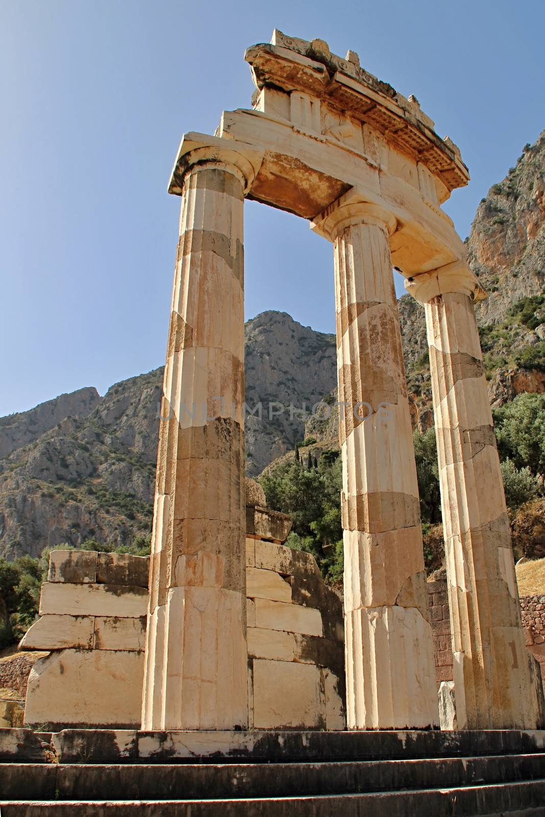 Photo shows old Delphi temple in the middle of the woods.