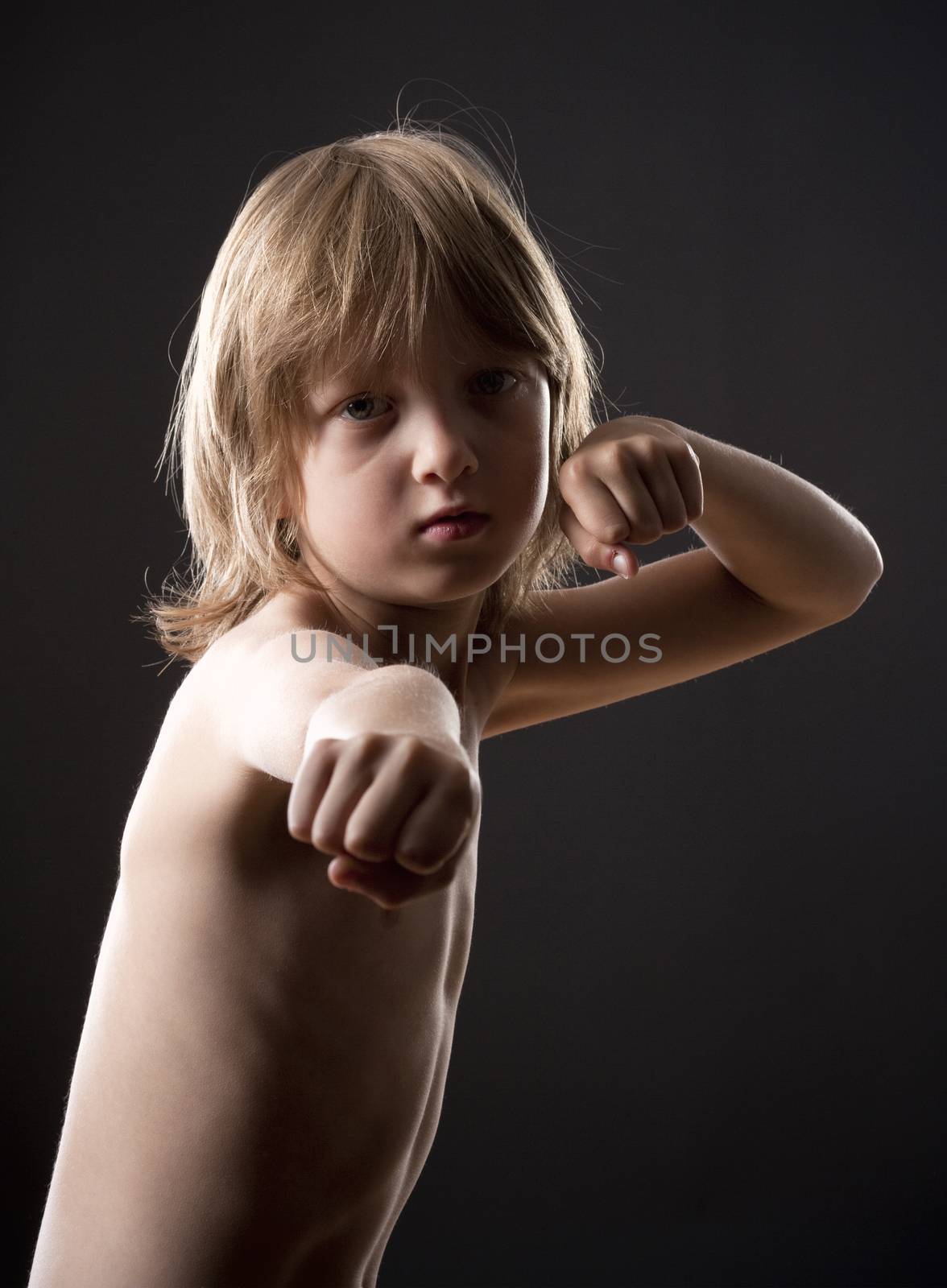 Boy with Blond Hair Striking a Fighting Pose