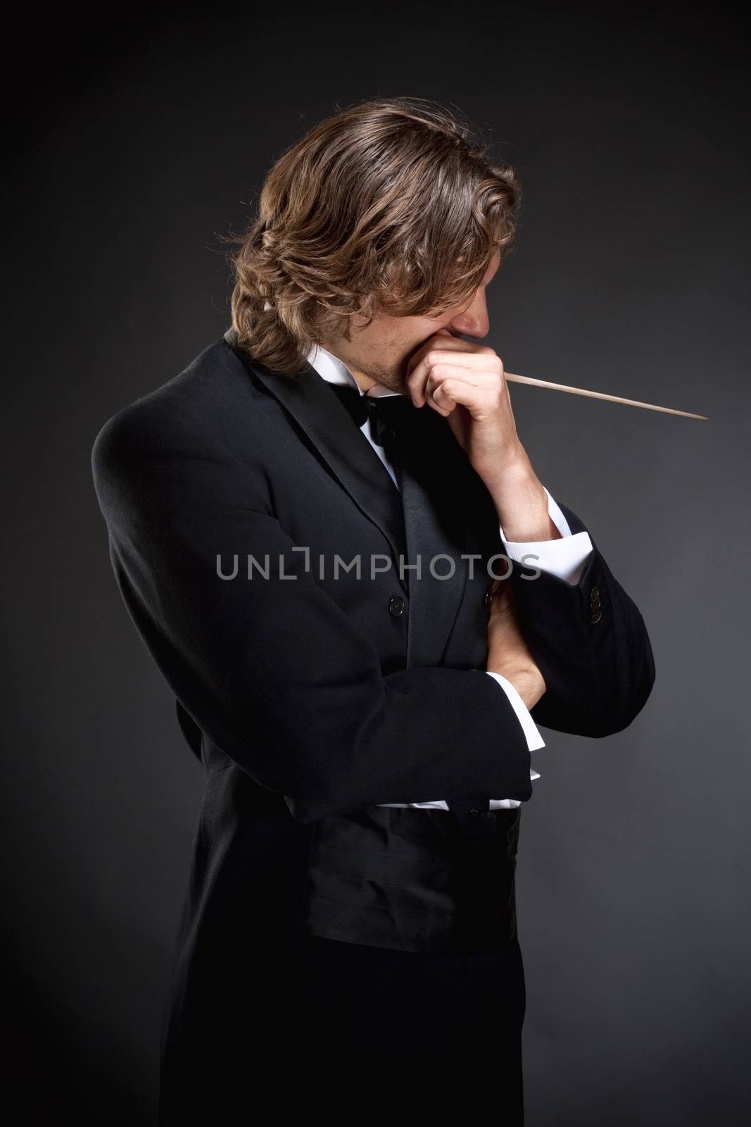 Young Conductor Holding a Baton Thinking