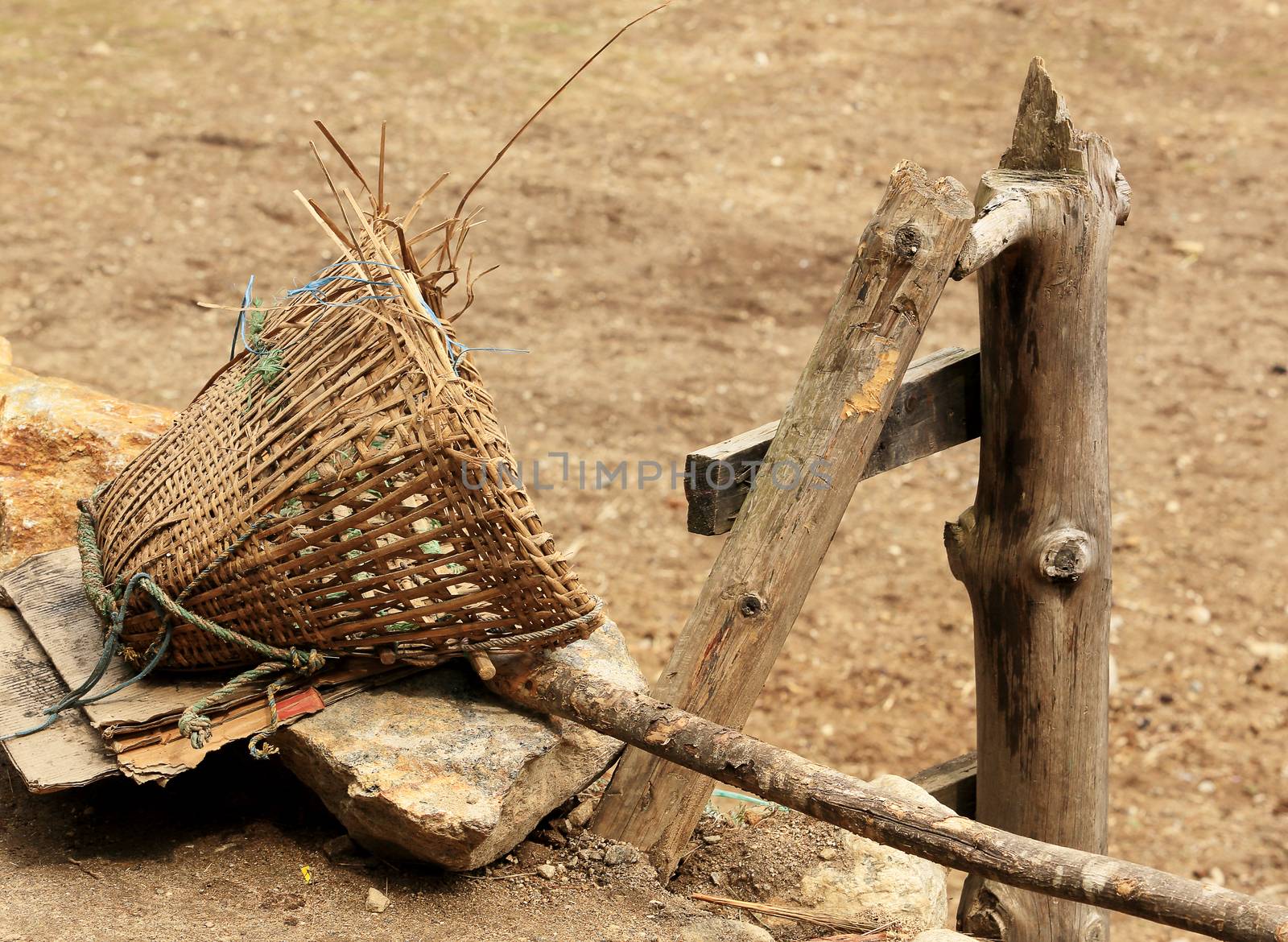 Old Nepalese basket rests on a stone. Nepal by aptyp_kok