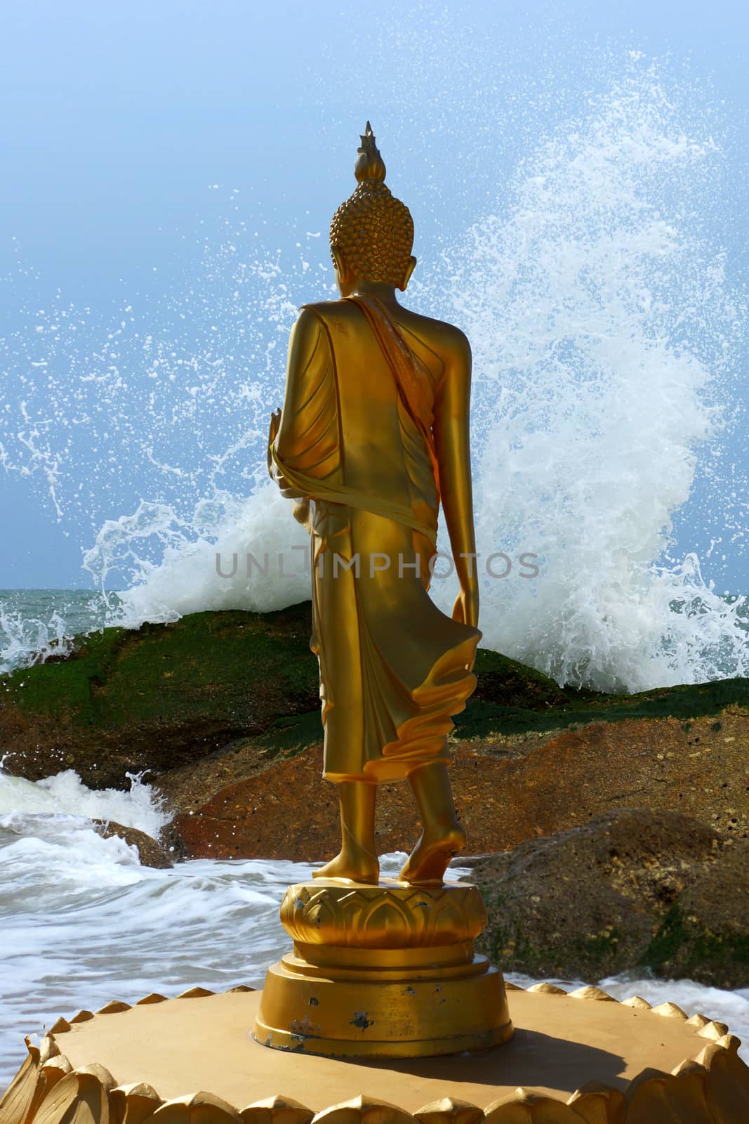 Buddha statues was walking on the beach and wave by Noppharat_th