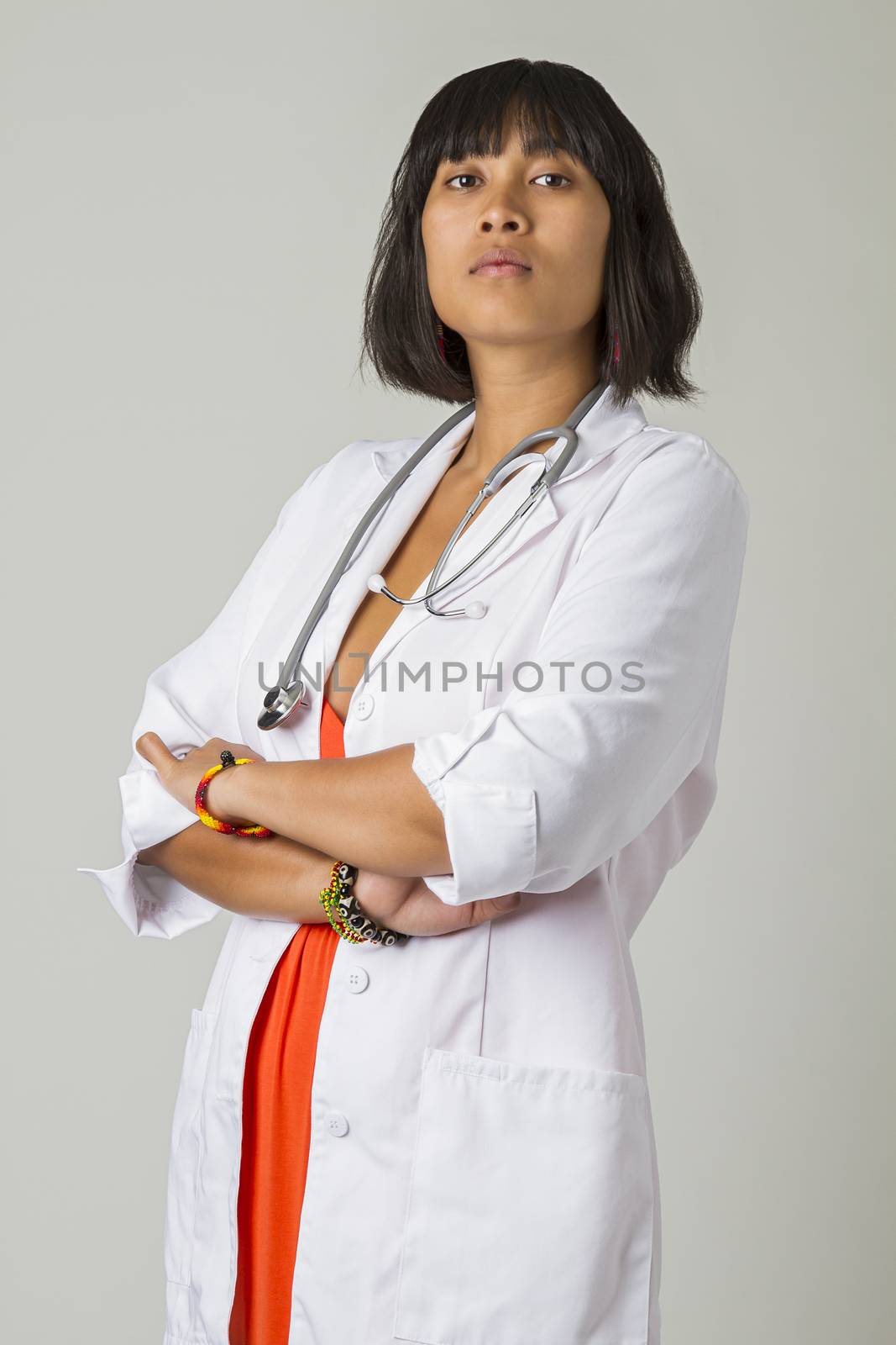 Young asian woman wearing a lab coat and a stethoscope