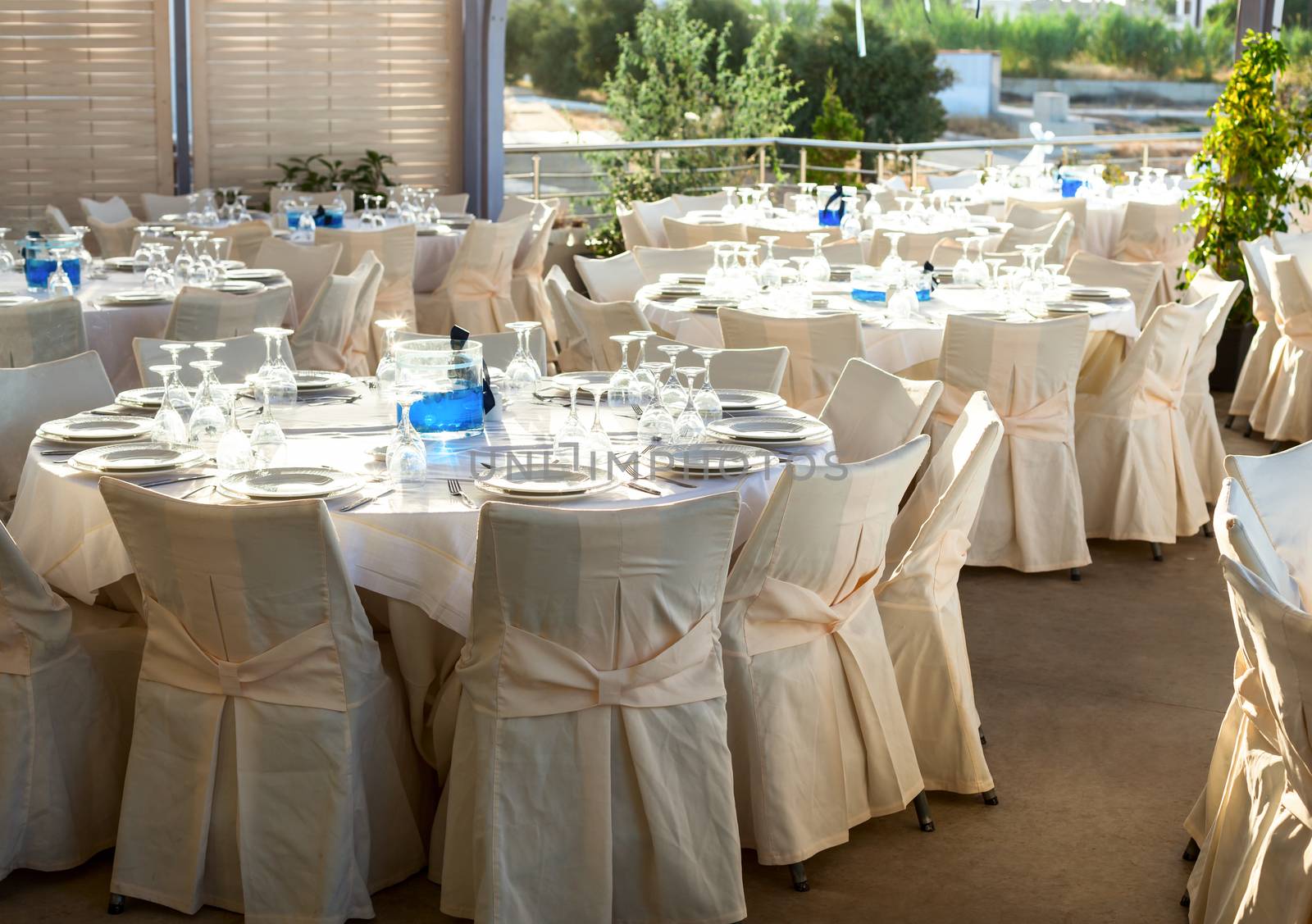 Table setting for an event party at outdoor cafe in the evening light