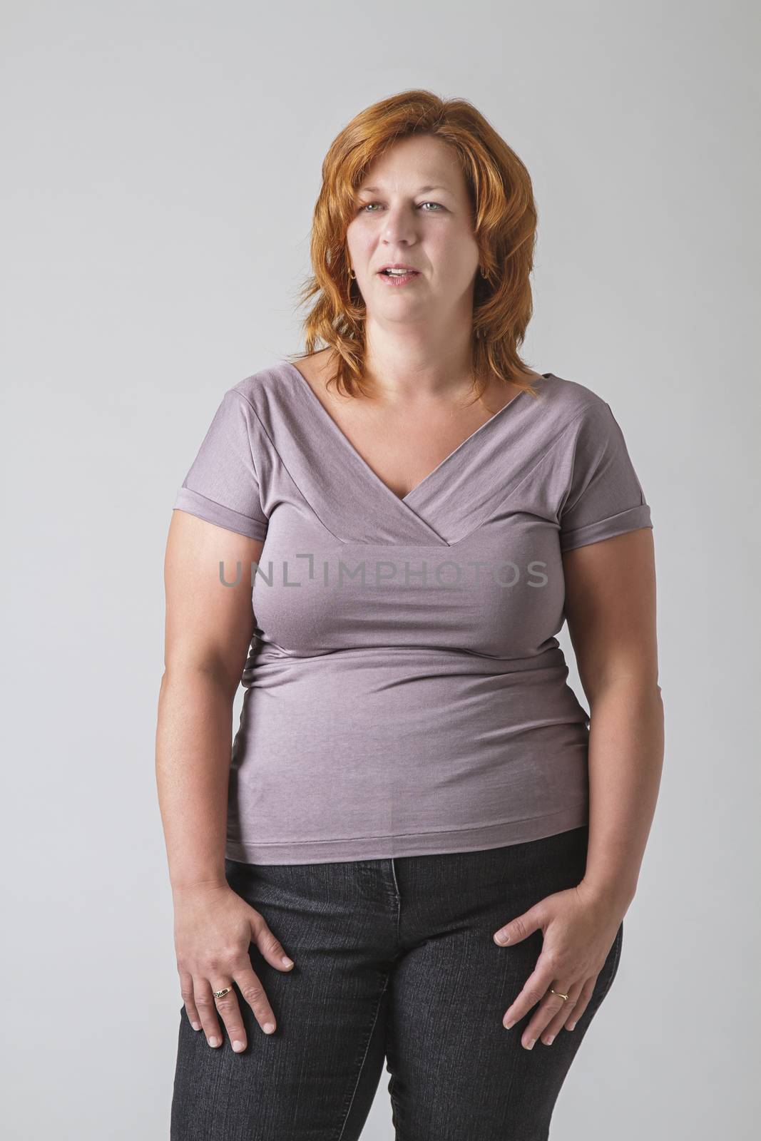 Forty year old woman against a gray background