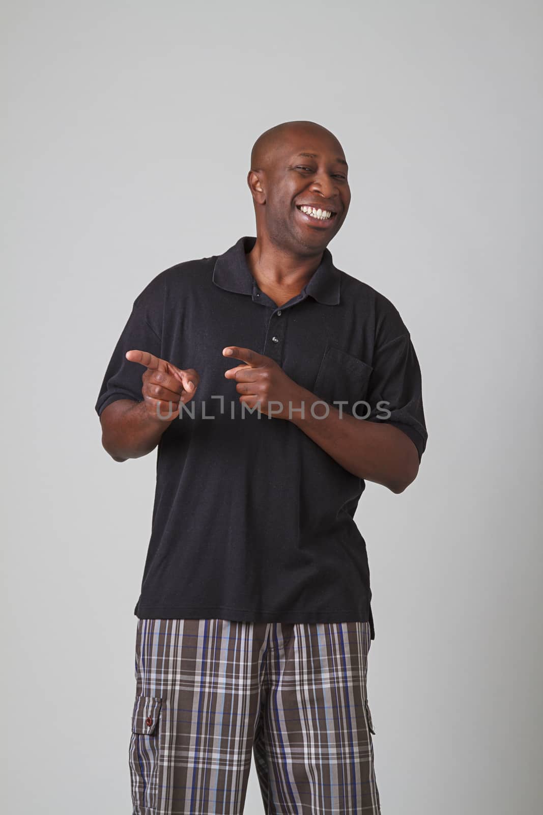 bald black man pointing to the left