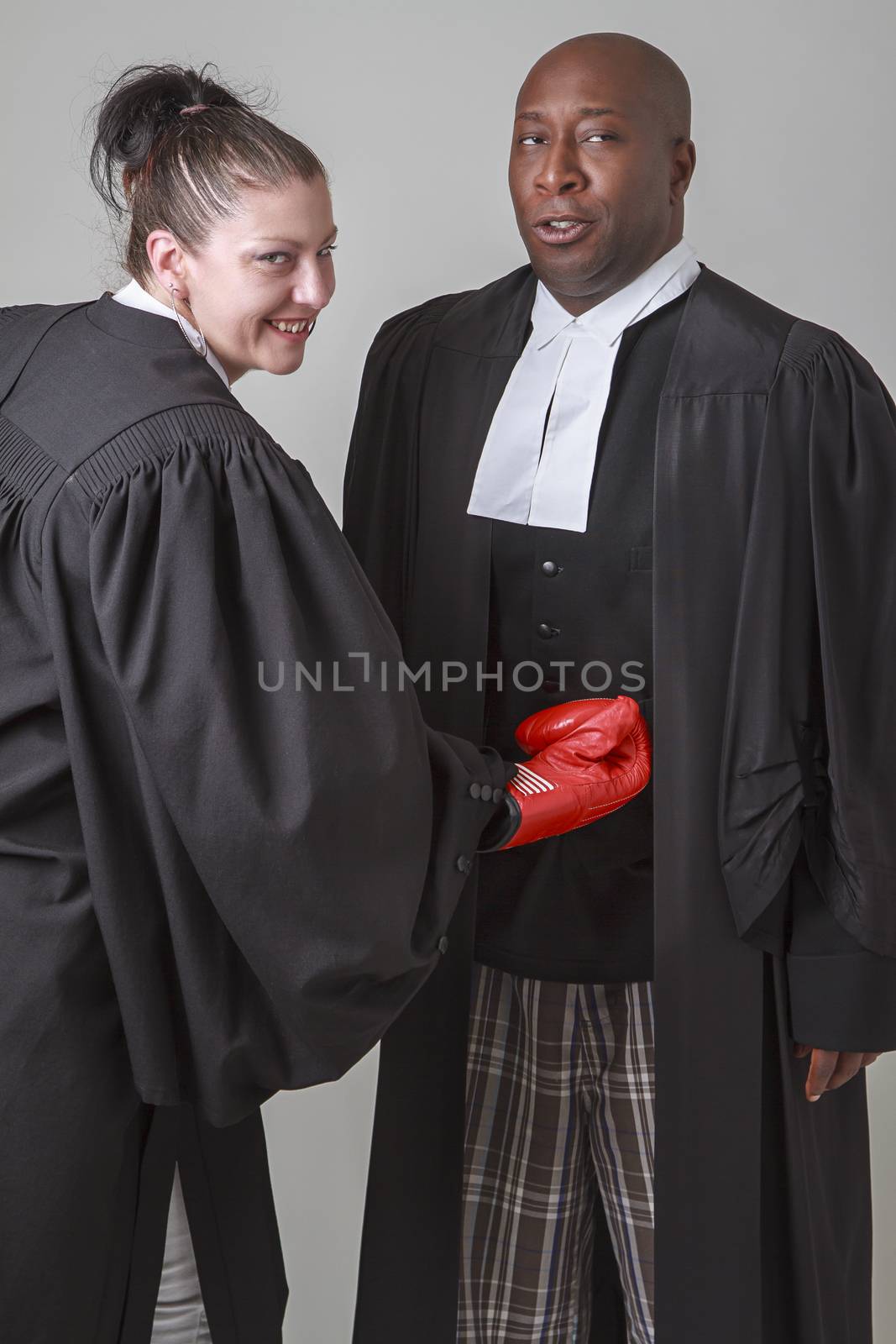 a woman lawyer punching a man lawyer into the guts