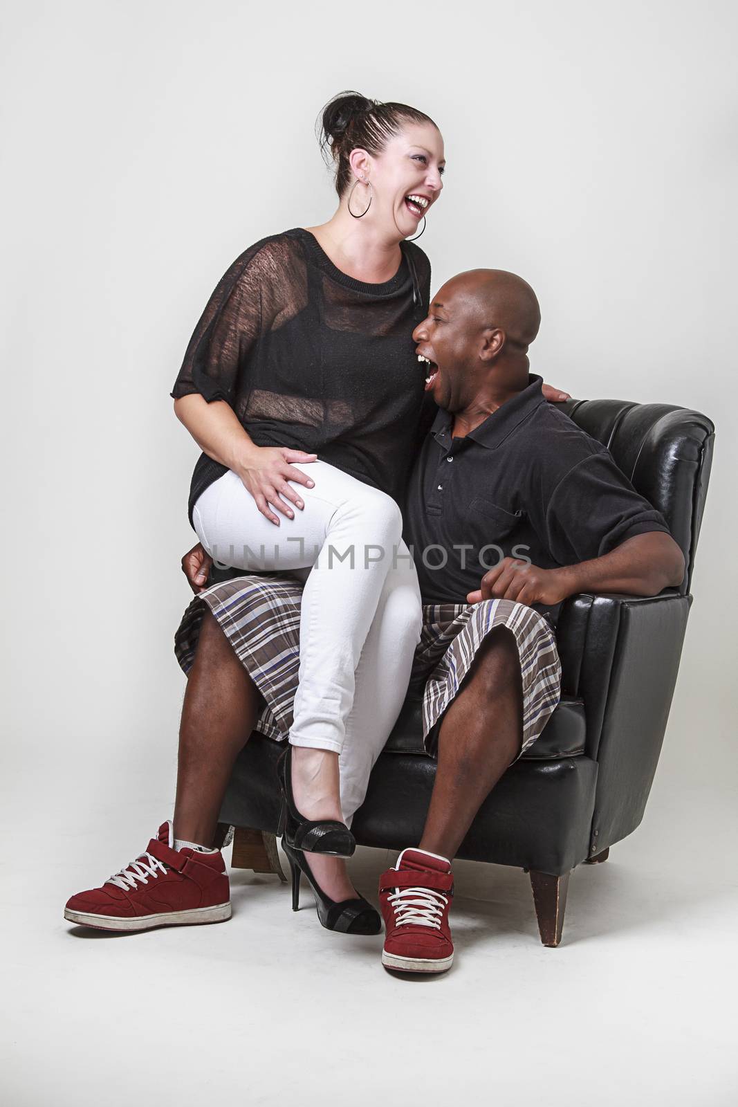 man making a woman laugh by bitting her breast