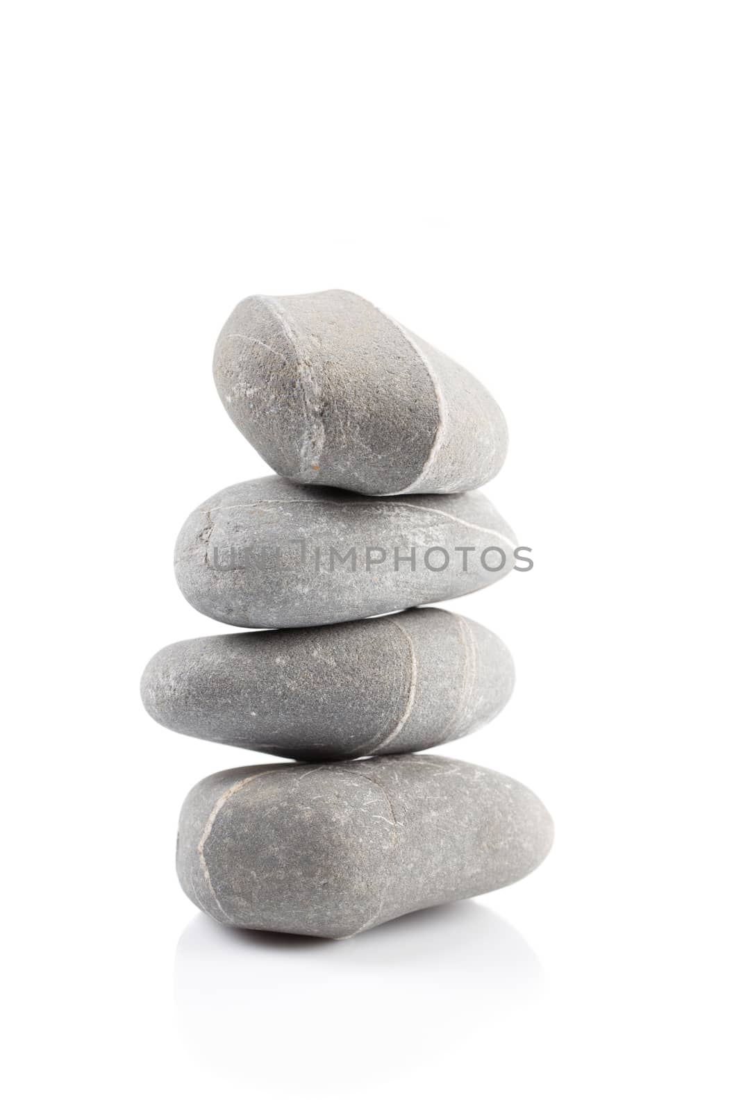 Pyramid of stones over white with reflection shadow