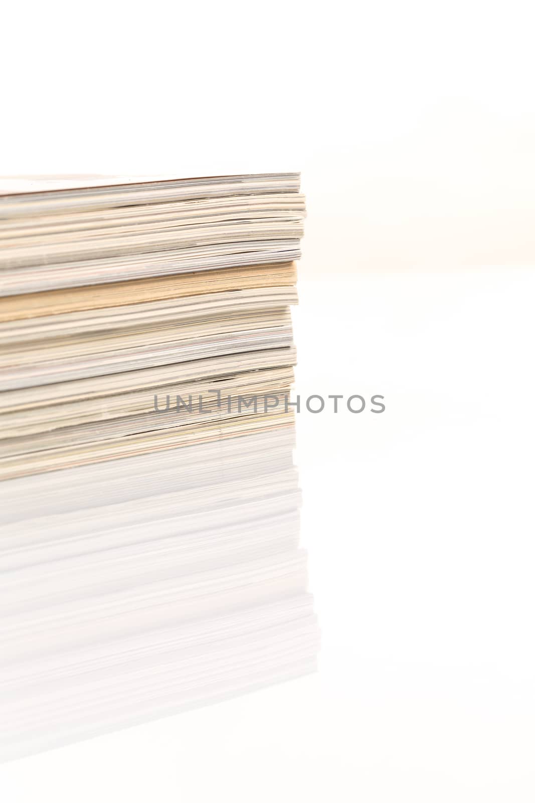 Сolorful magazines up close shot on white background with reflection