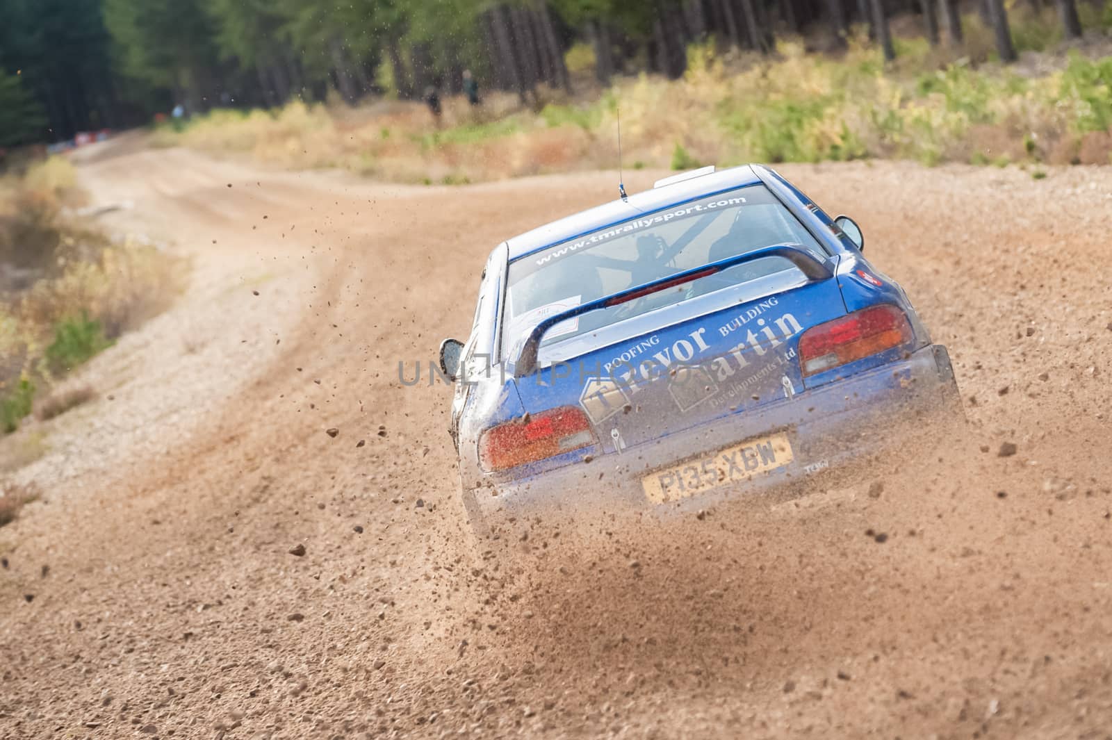 Bramshill Forest, UK - November 3, 2012: Driver Trevor Martin kicking up dust in a Subaru Impreza on the Warren stage of the MSA Tempest Rally in Bramshill Forest, UK