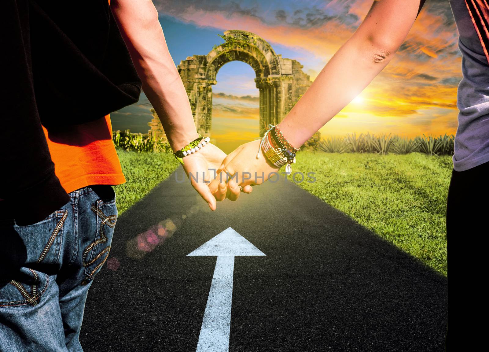 View of lovers couple holding hands on the road