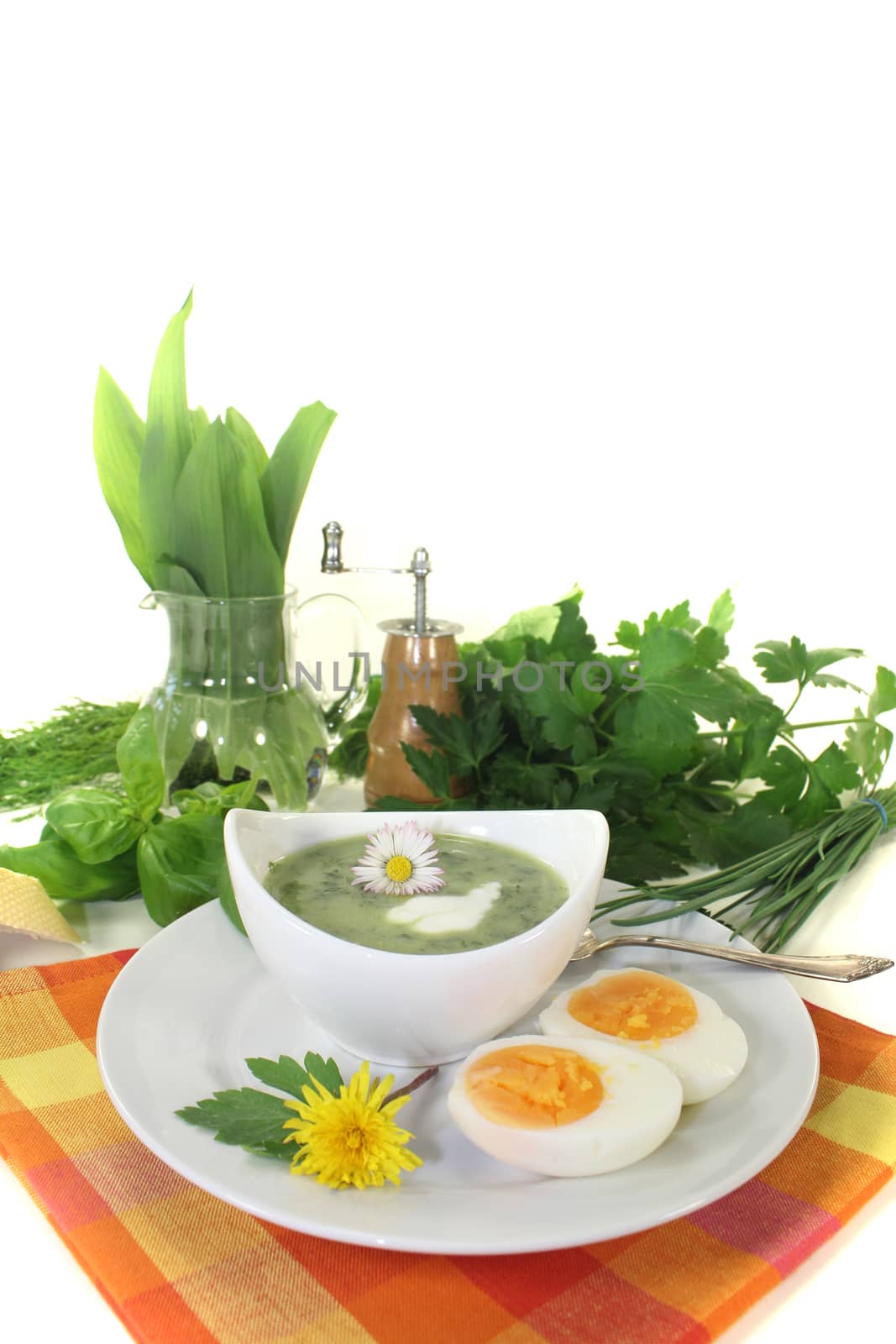 green herb soup with eggs and a dollop of cream by discovery