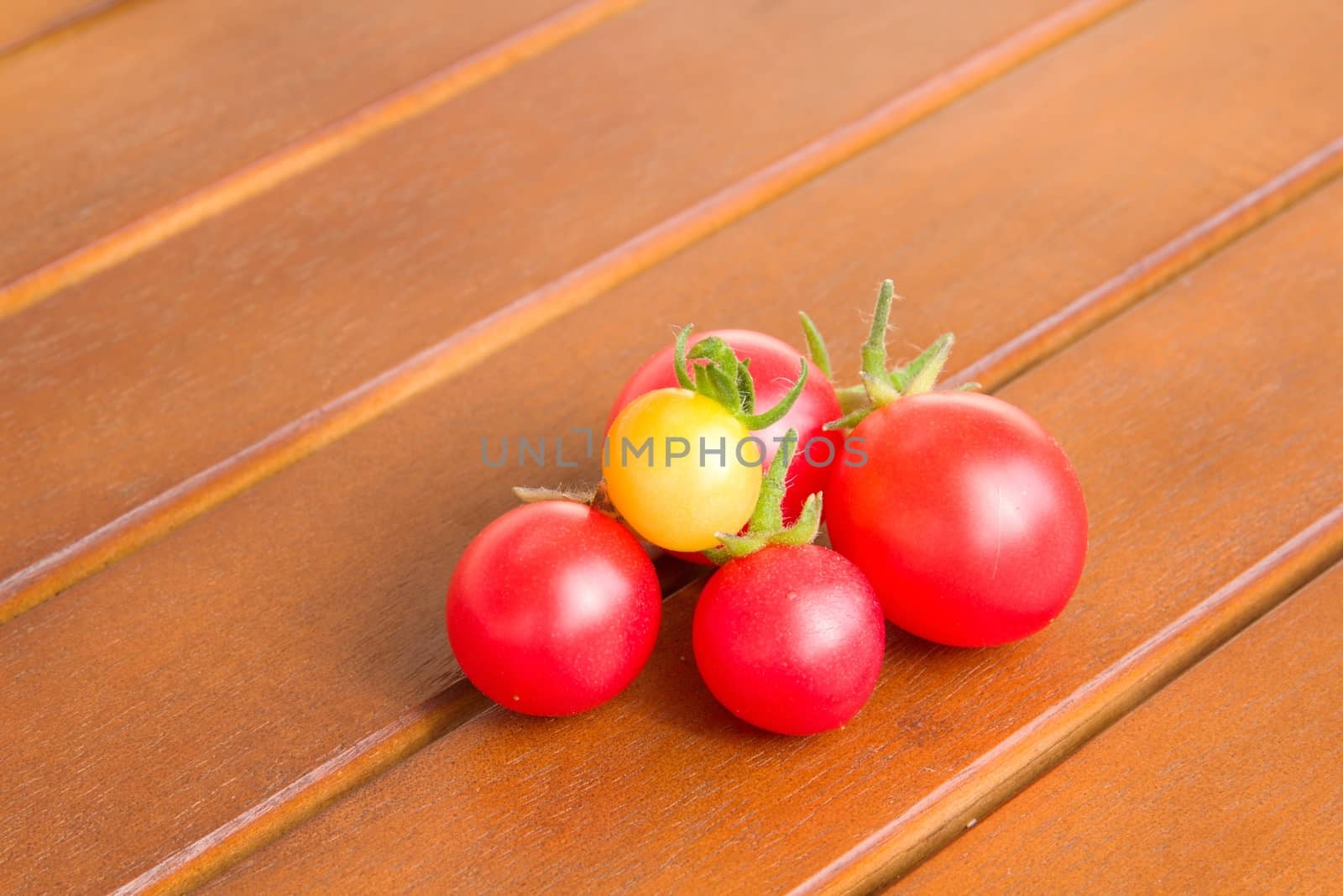 Colourful tomatoes on a table by Dermot68