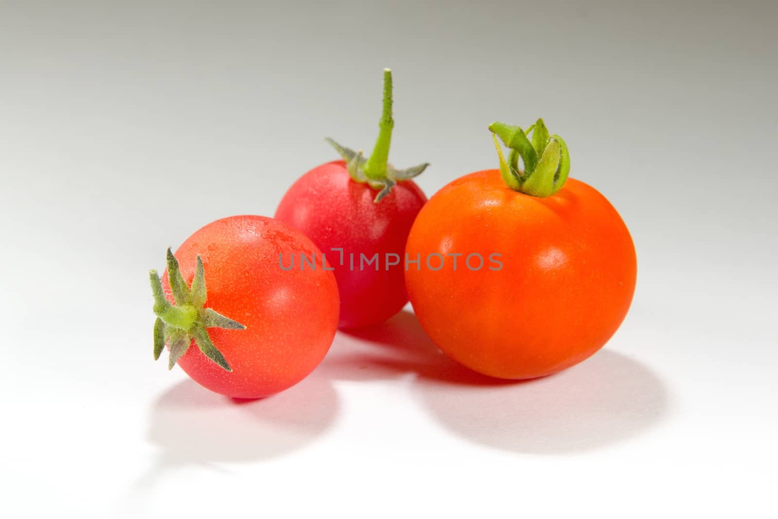 Photo shows a detail of the colourful tomatoes on a table.