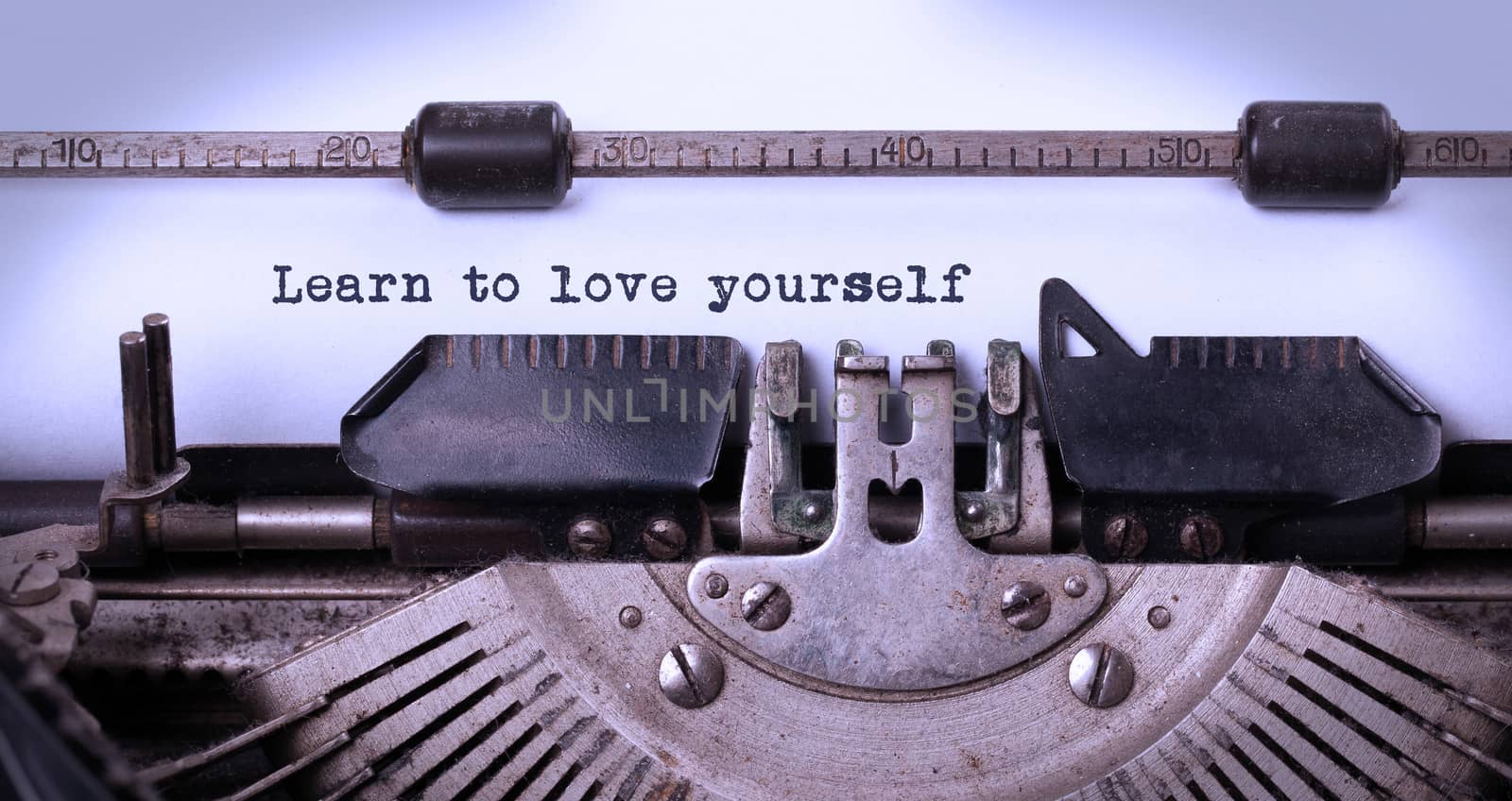 Vintage inscription made by old typewriter, learn to love yourself