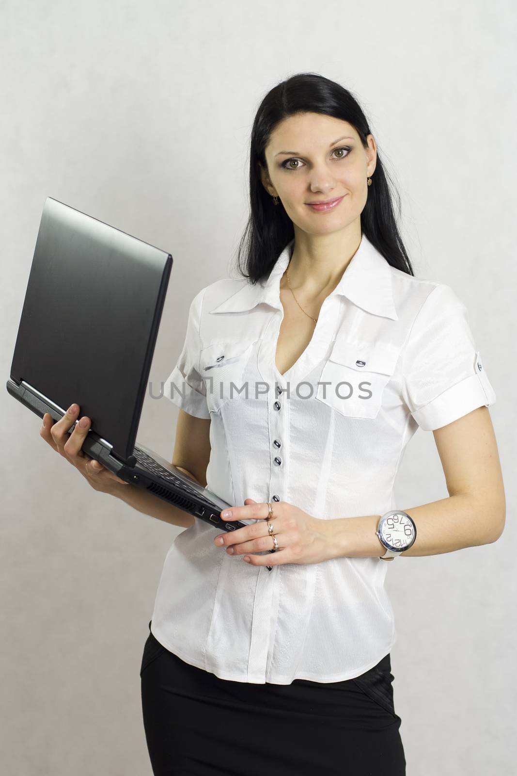 Business girl with a laptop. Studio, a white background.