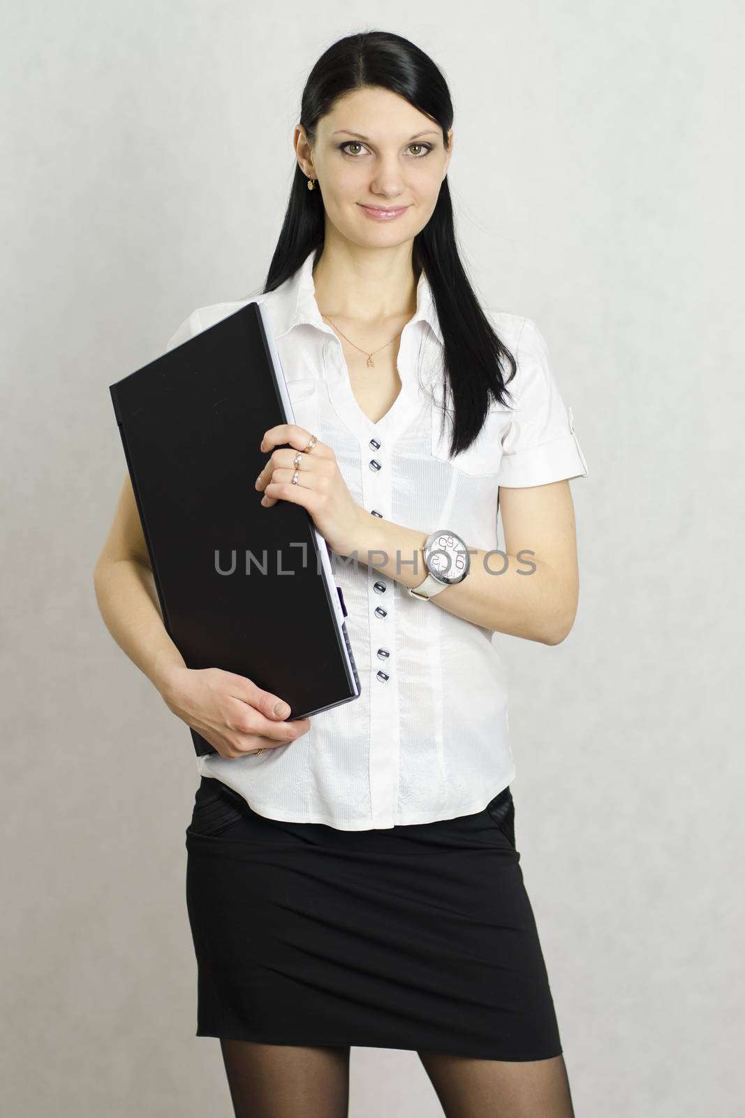 Business girl with a laptop. Studio, a white background.
