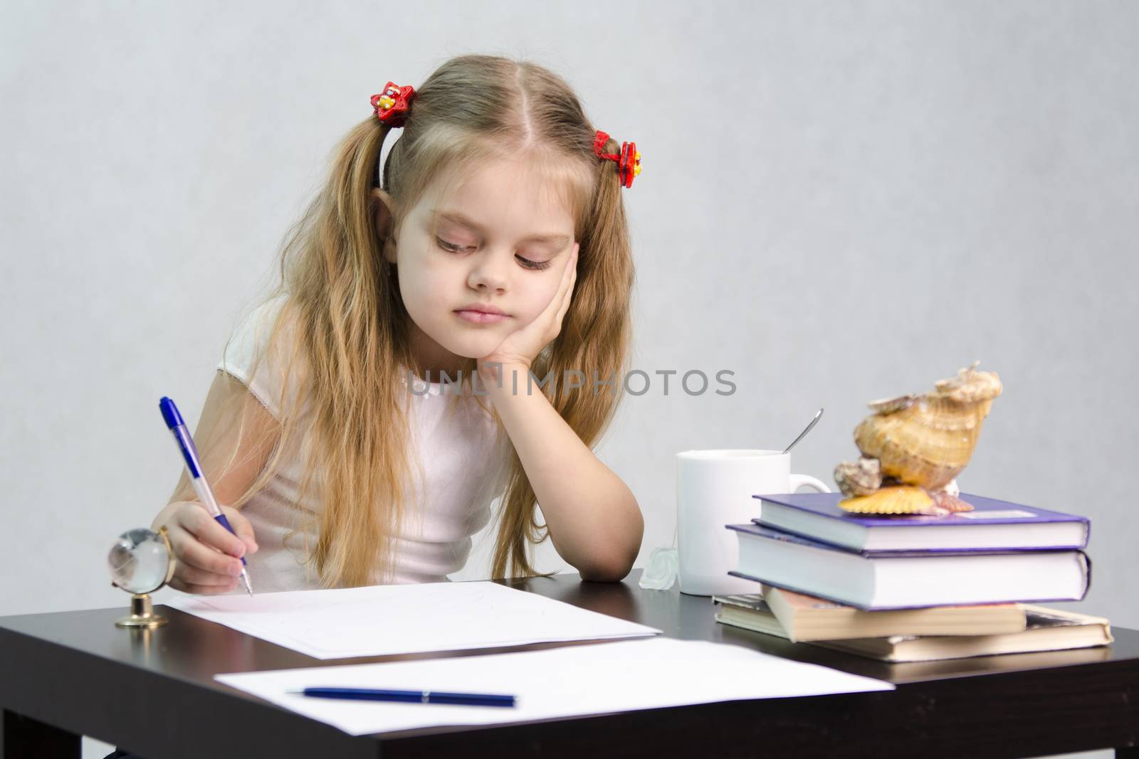 girl sits at a table and wrote on a sheet of paper. There are tombs of books, sheets of paper, a pen, glass globe, with a glass of tea, sea shell. The image of the writer