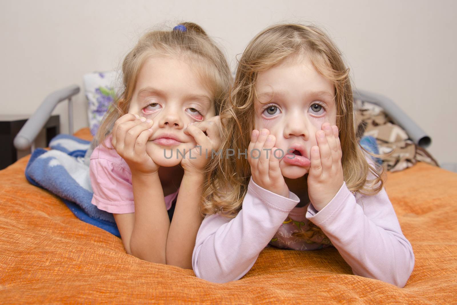 The two girls pulled a terrible faces, lying on the couch