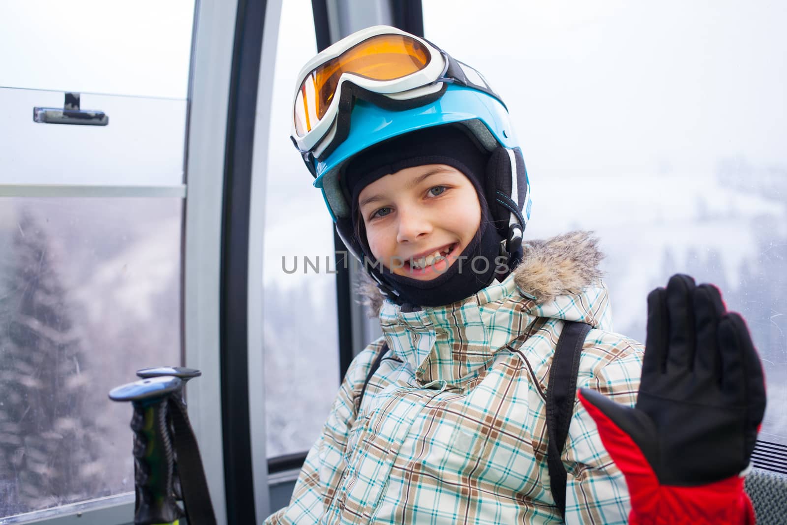 Ski lift, skiing, ski resort - happy skier girl on ski lift.