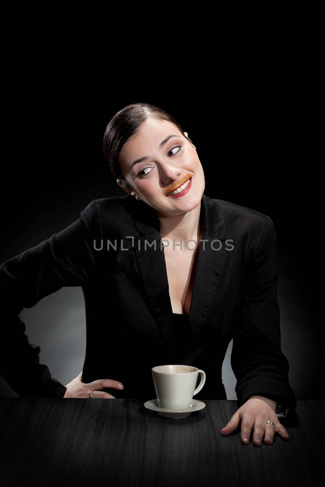 beautiful girl enjoying a cup of coffee on dark background