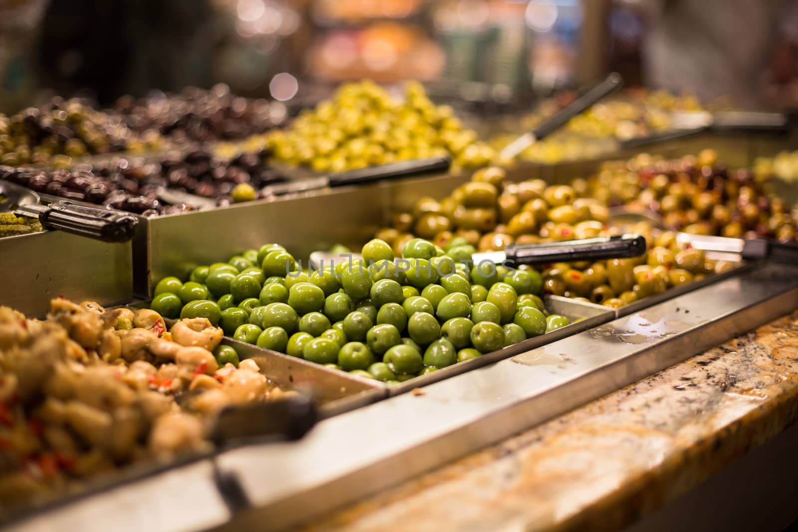 Olives on sale/display in a food market/grocery store by viktor_cap