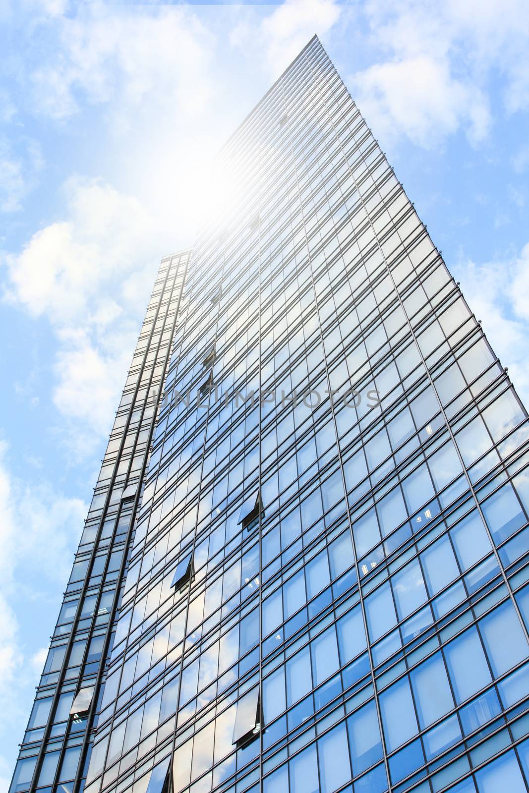 glass wall of office building,with reflection of clouds