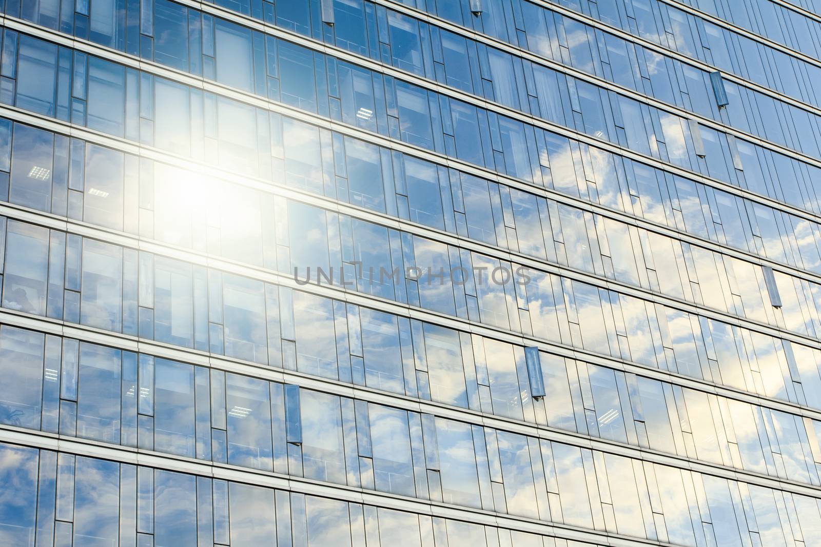 glass wall of office building,with reflection of clouds
