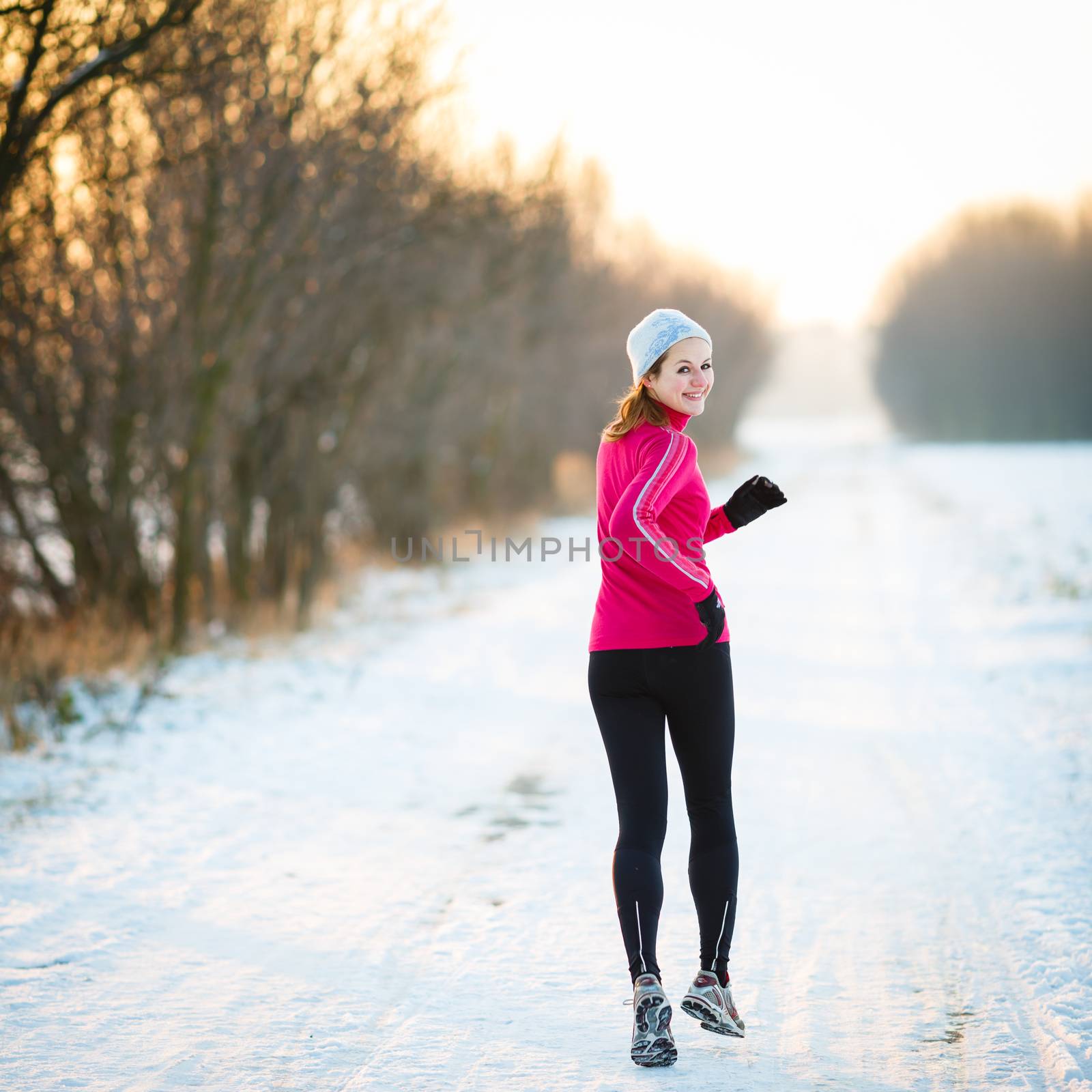 Young woman running outdoors on a cold winter day by viktor_cap
