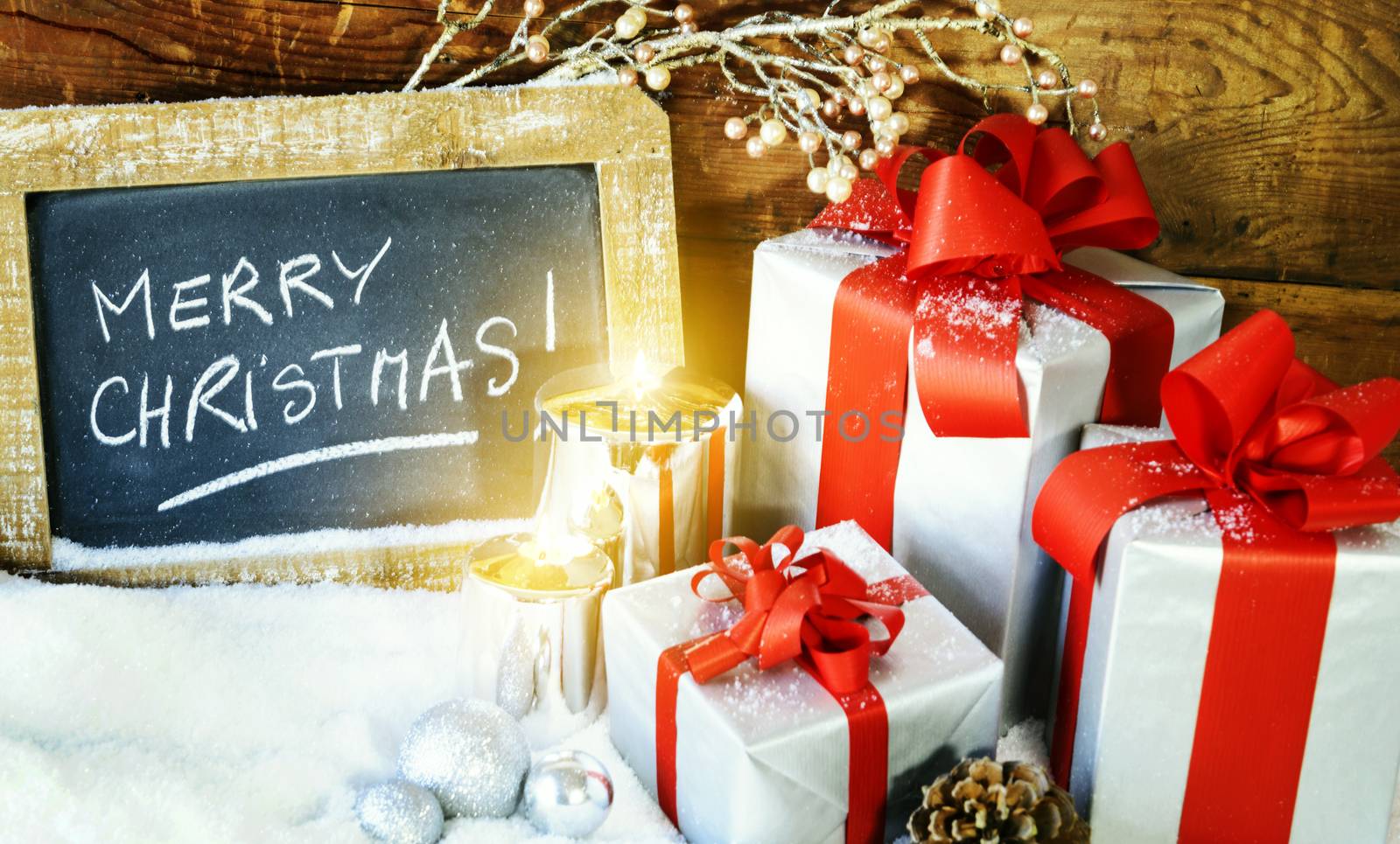 Closeup of Christmas gifts with candle and slate. 