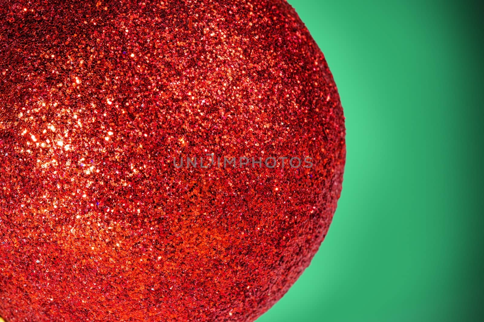 Abstract macro picture of a christmas ball with green background