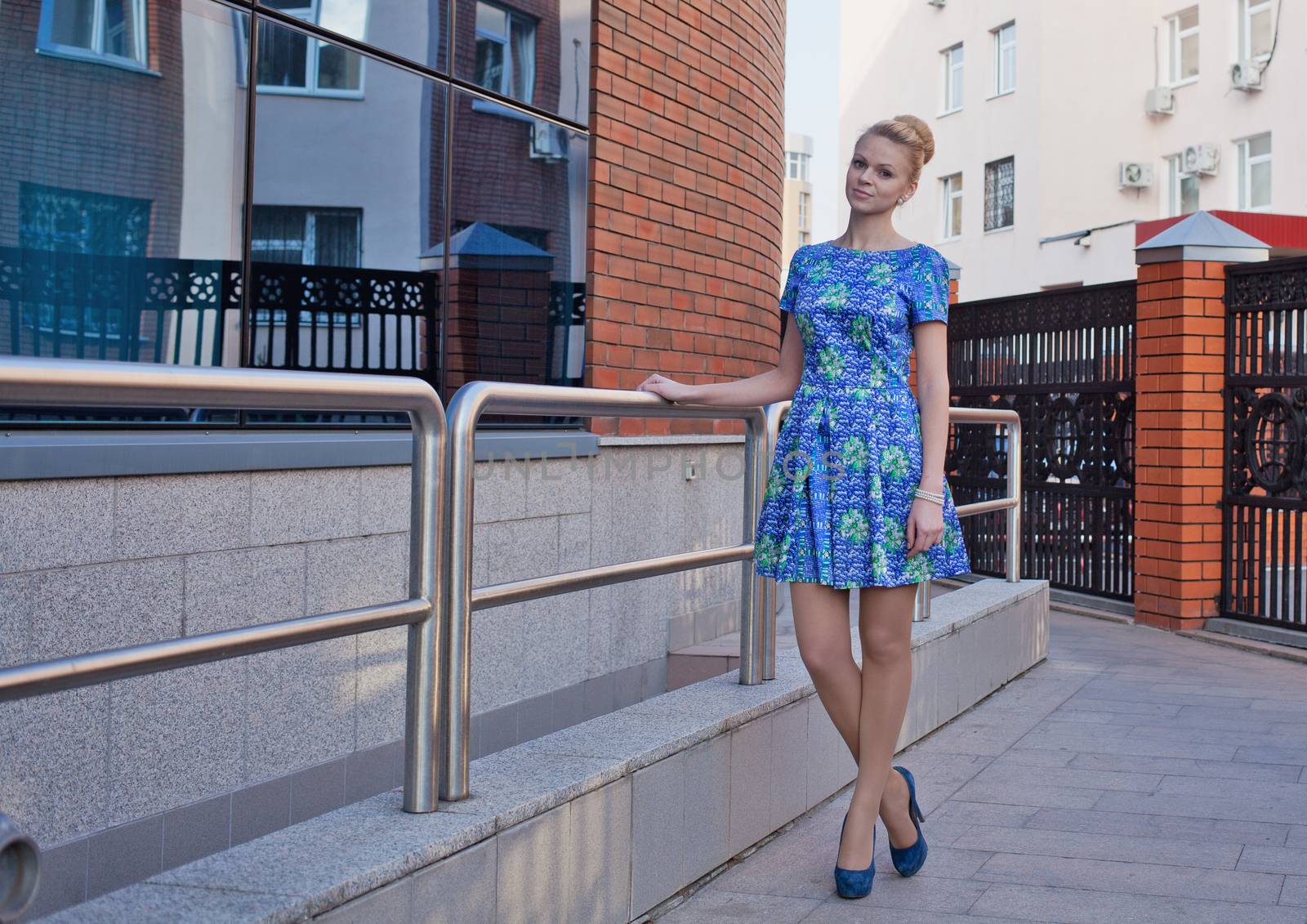 Young girl blonde in blue short dress by fotooxotnik