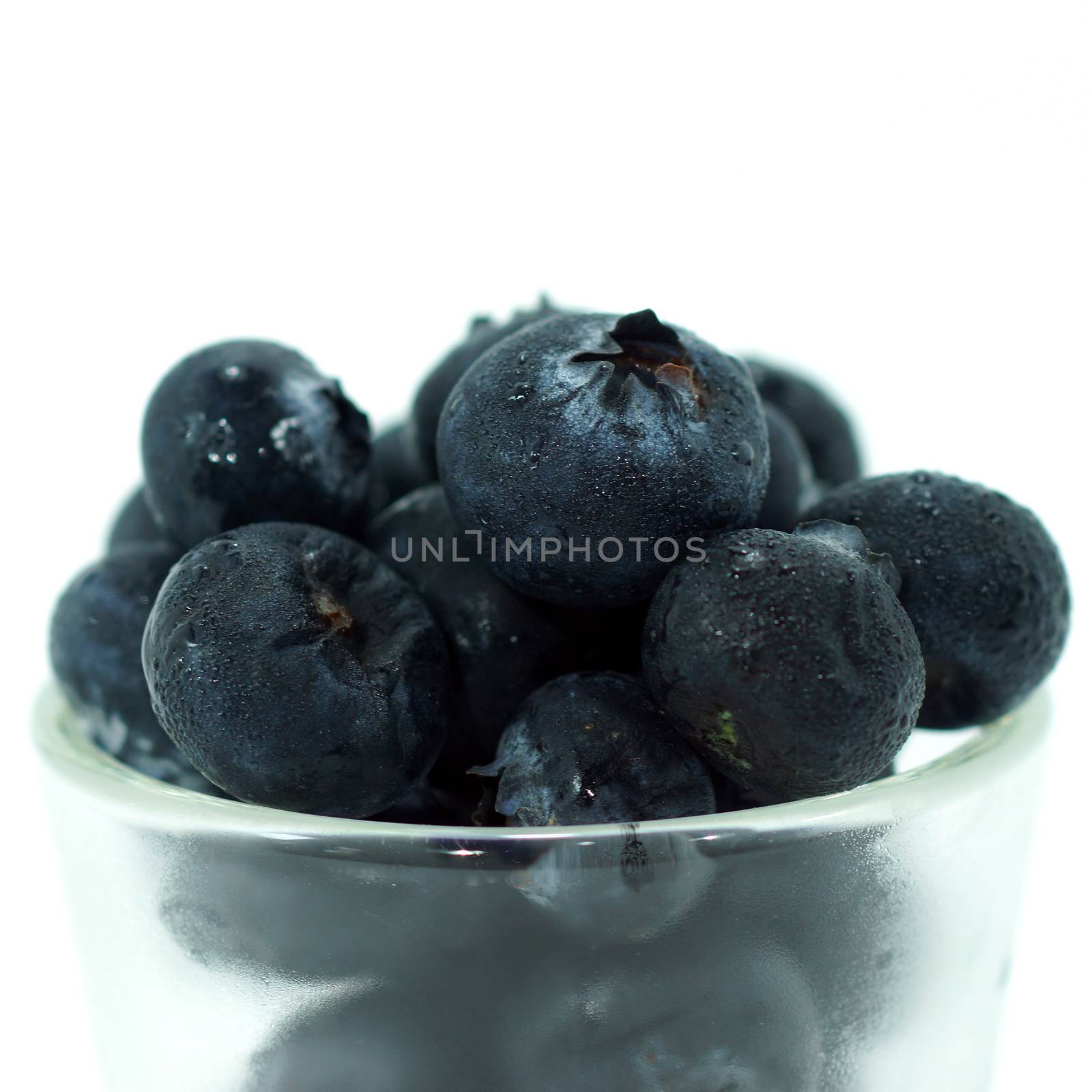 Blueberries with leaves on white background by Noppharat_th