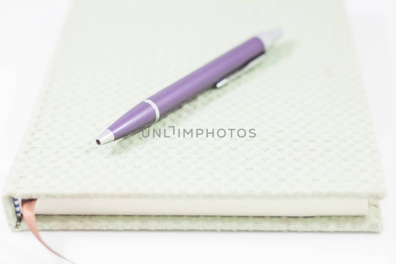 Closeup notebook and pen on white background, stock photo