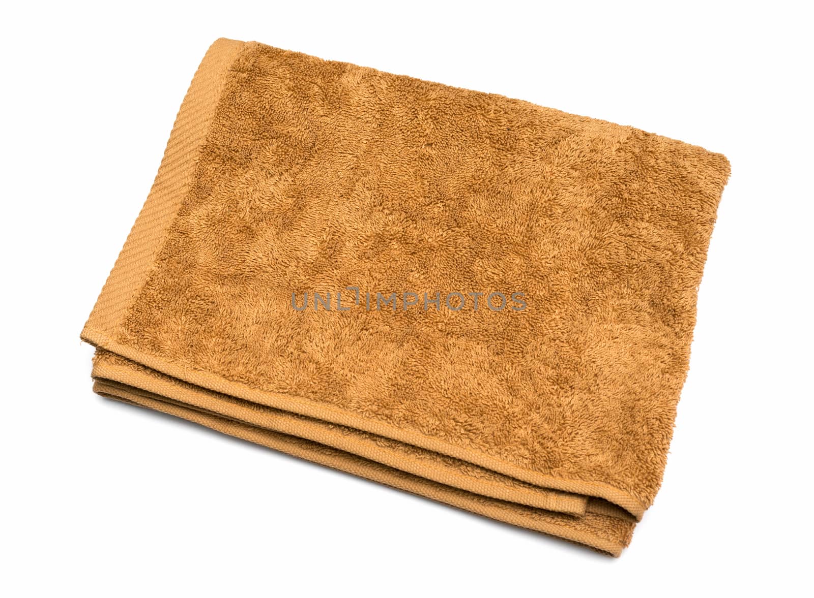 Light brown folded towel on white