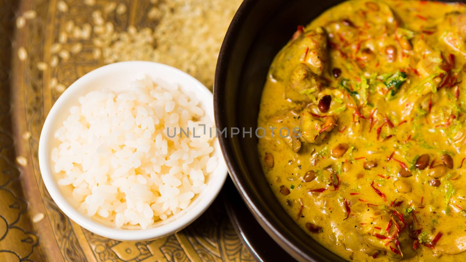 Chicken curry with rice and parsley in a bowl