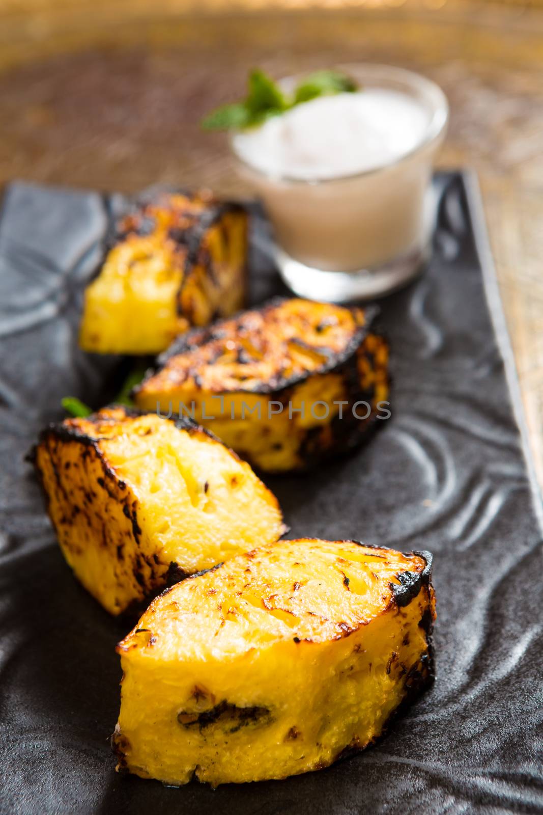 pineapple slices grilled. served with ice cream. dessert