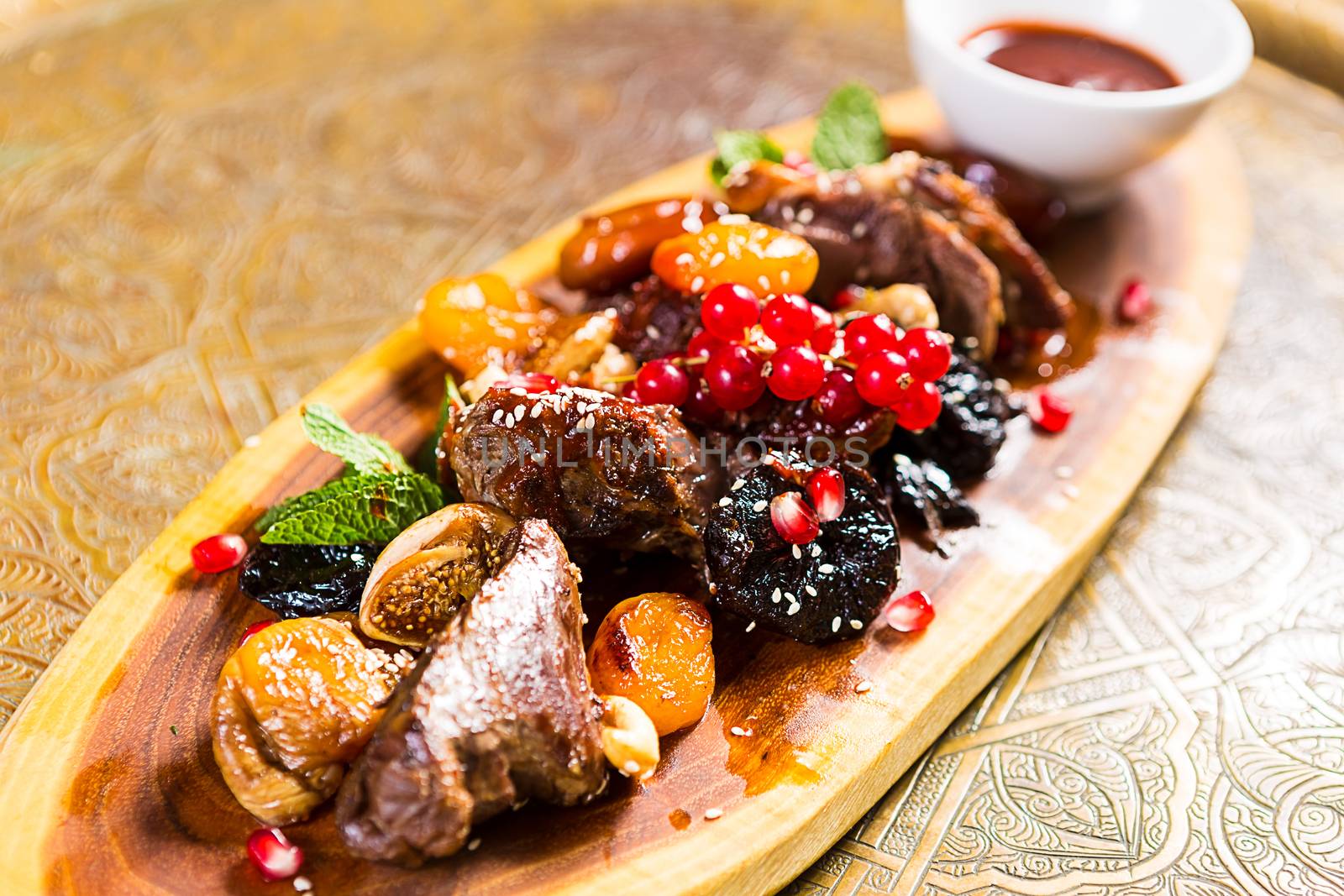 pieces of lamb cooked on the grill. served with fruit