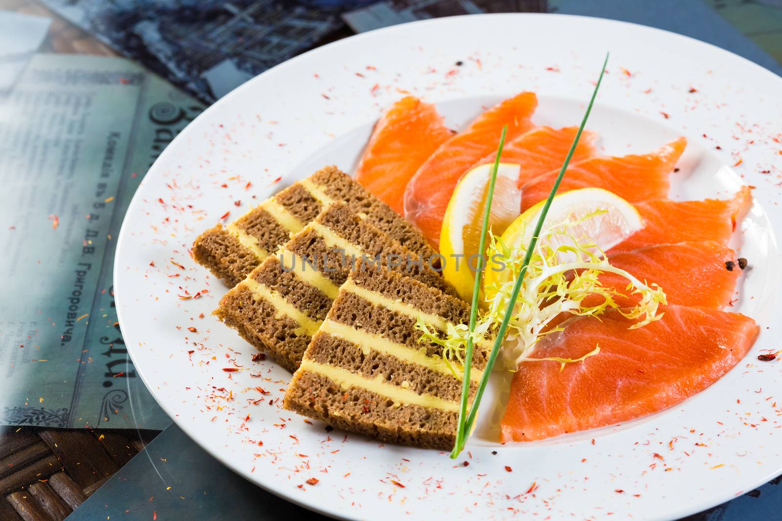 Salmon snack on the white plate, studio shot