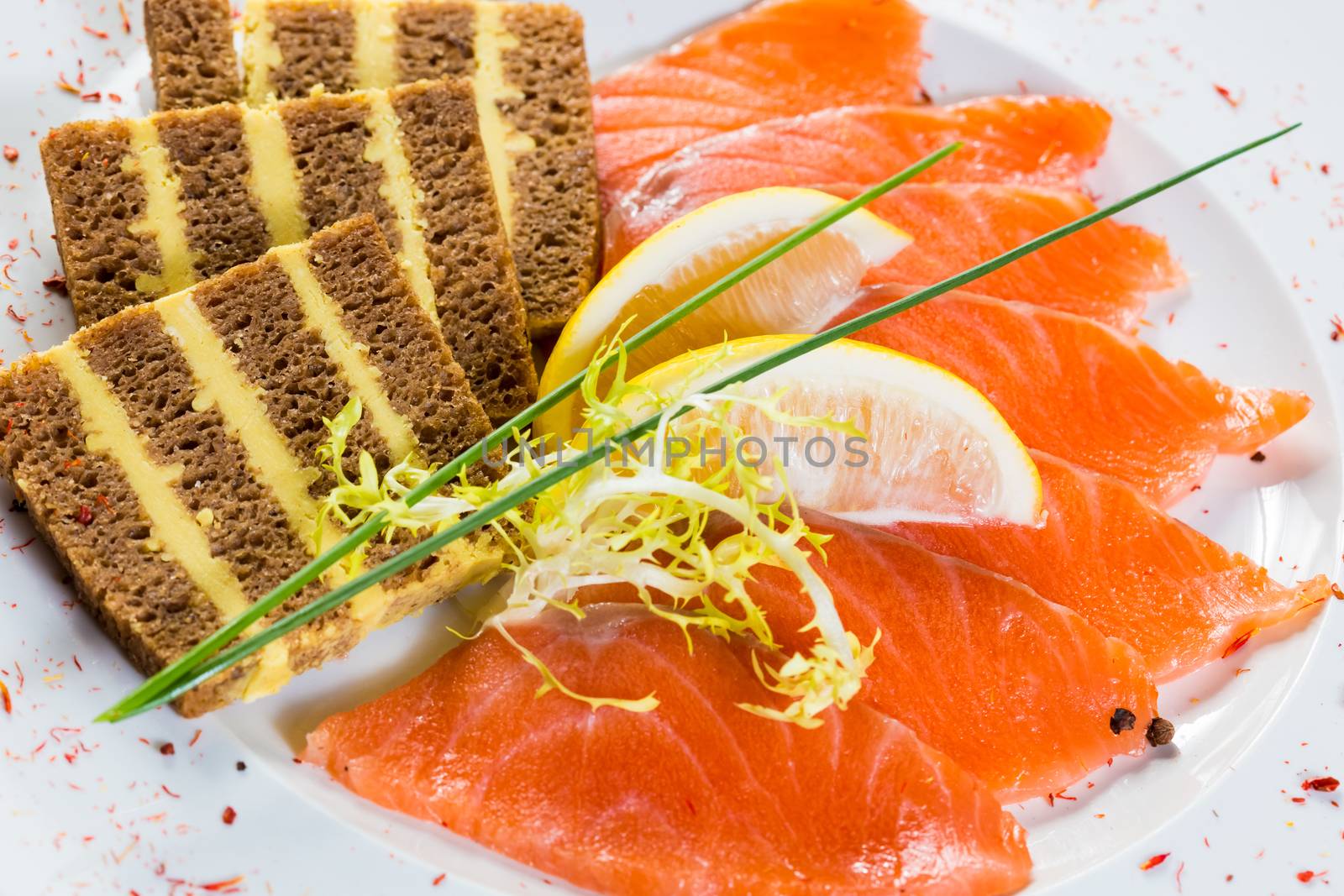 Salmon snack on the white plate, studio shot