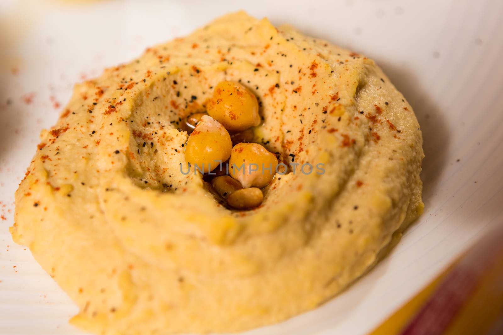 bowl of creamy hummus by sarymsakov