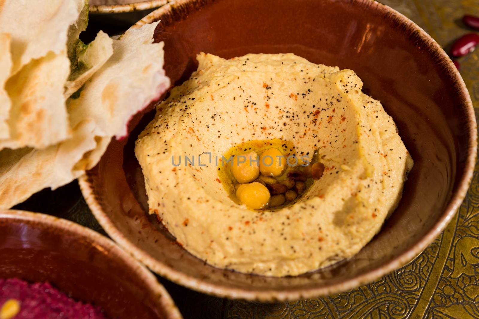 A bowl of creamy hummus with olive oil