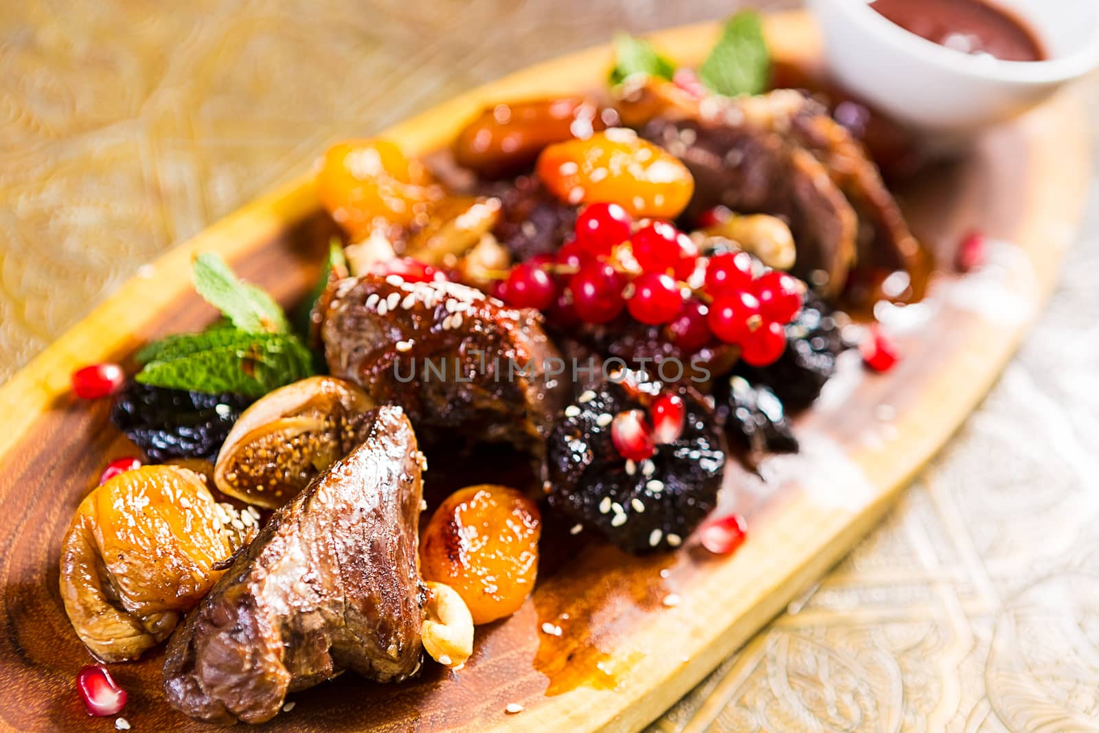 pieces of lamb cooked on the grill. served with fruit