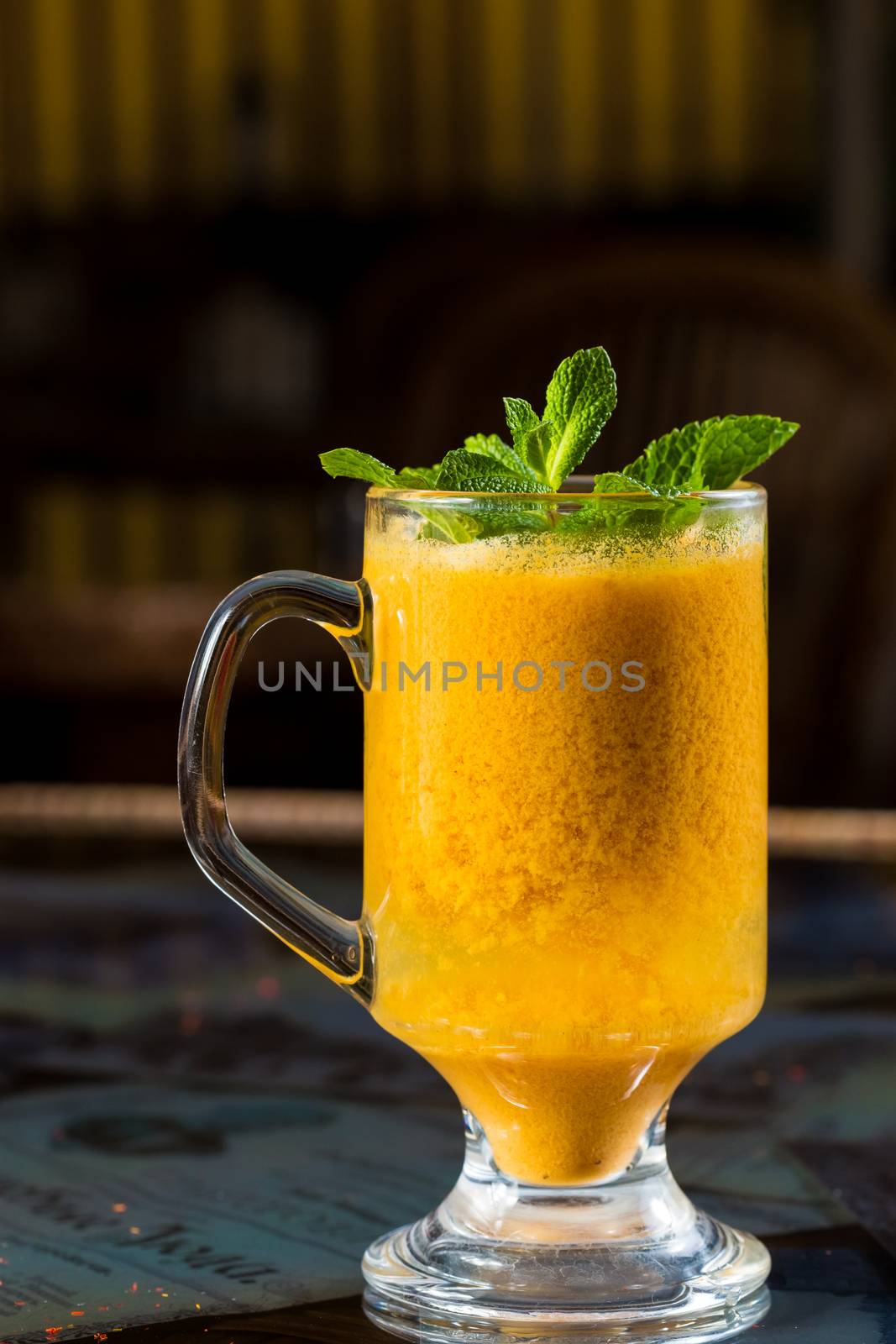 seabuckthorn tea in a glass cup decorated with mint leaves 
